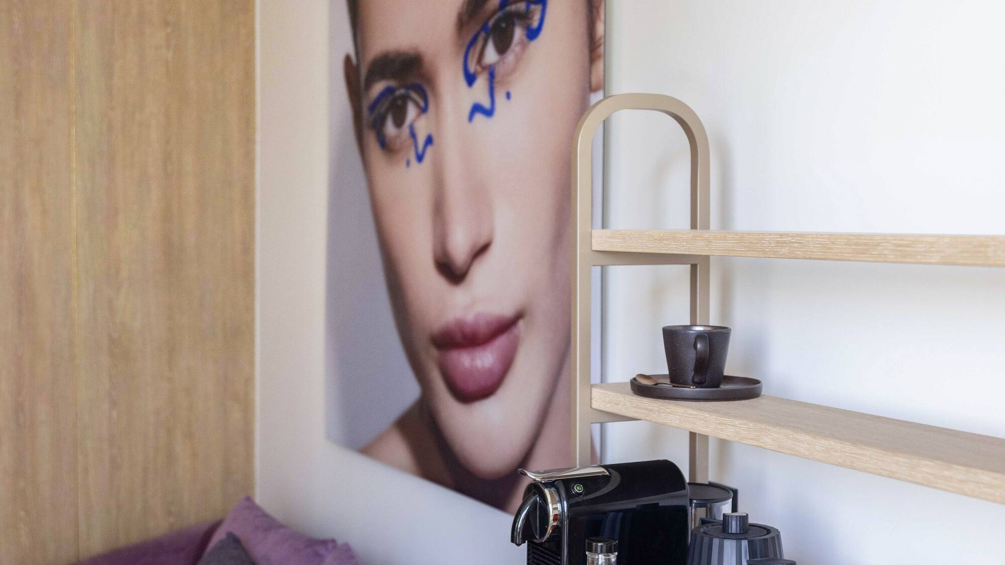 a coffee machine and a picture of a woman on a table