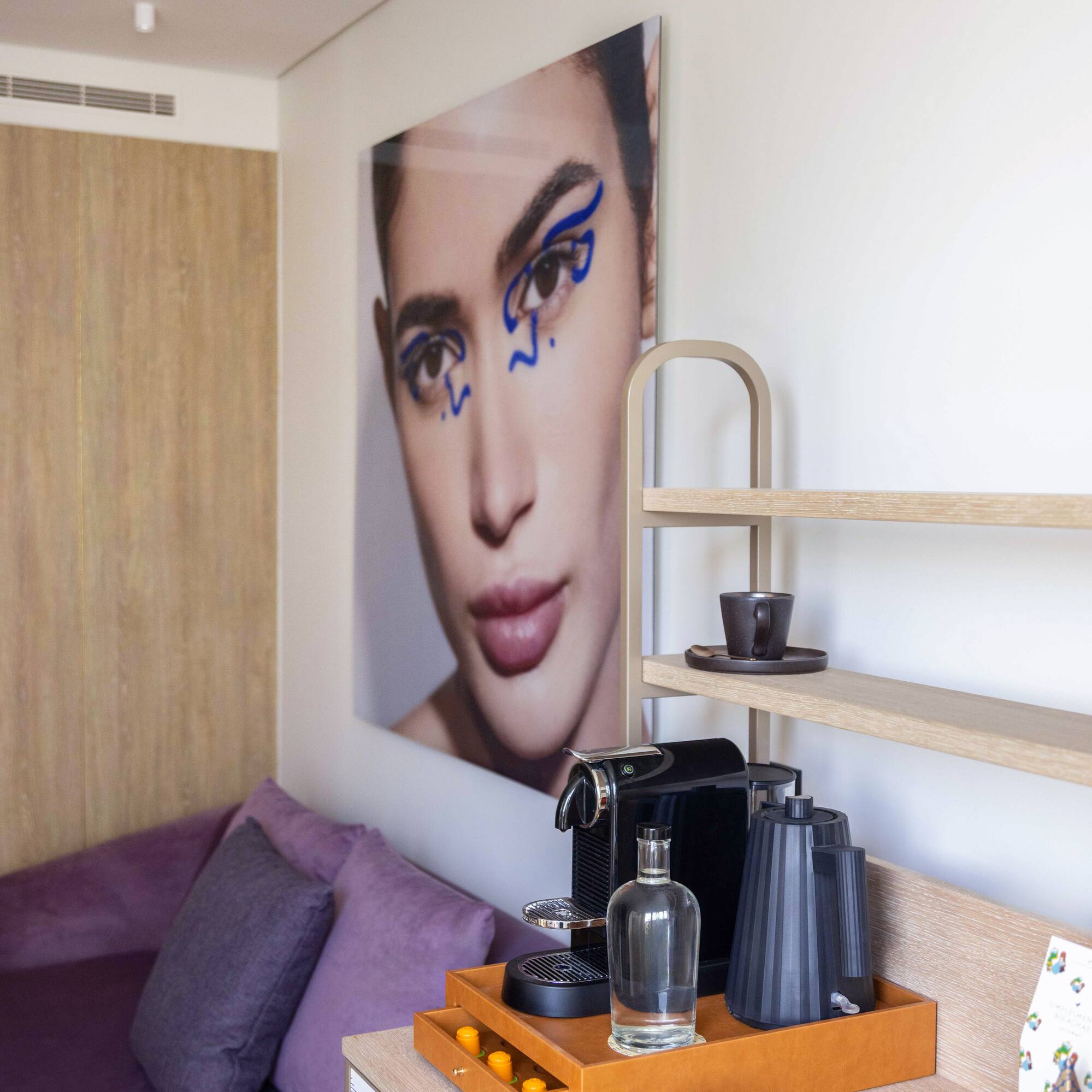 a coffee machine and a picture of a woman on a table