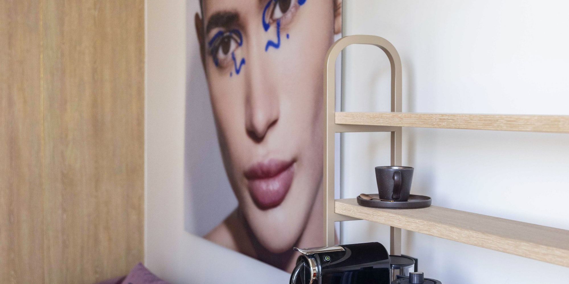 a coffee machine and a picture of a woman on a table