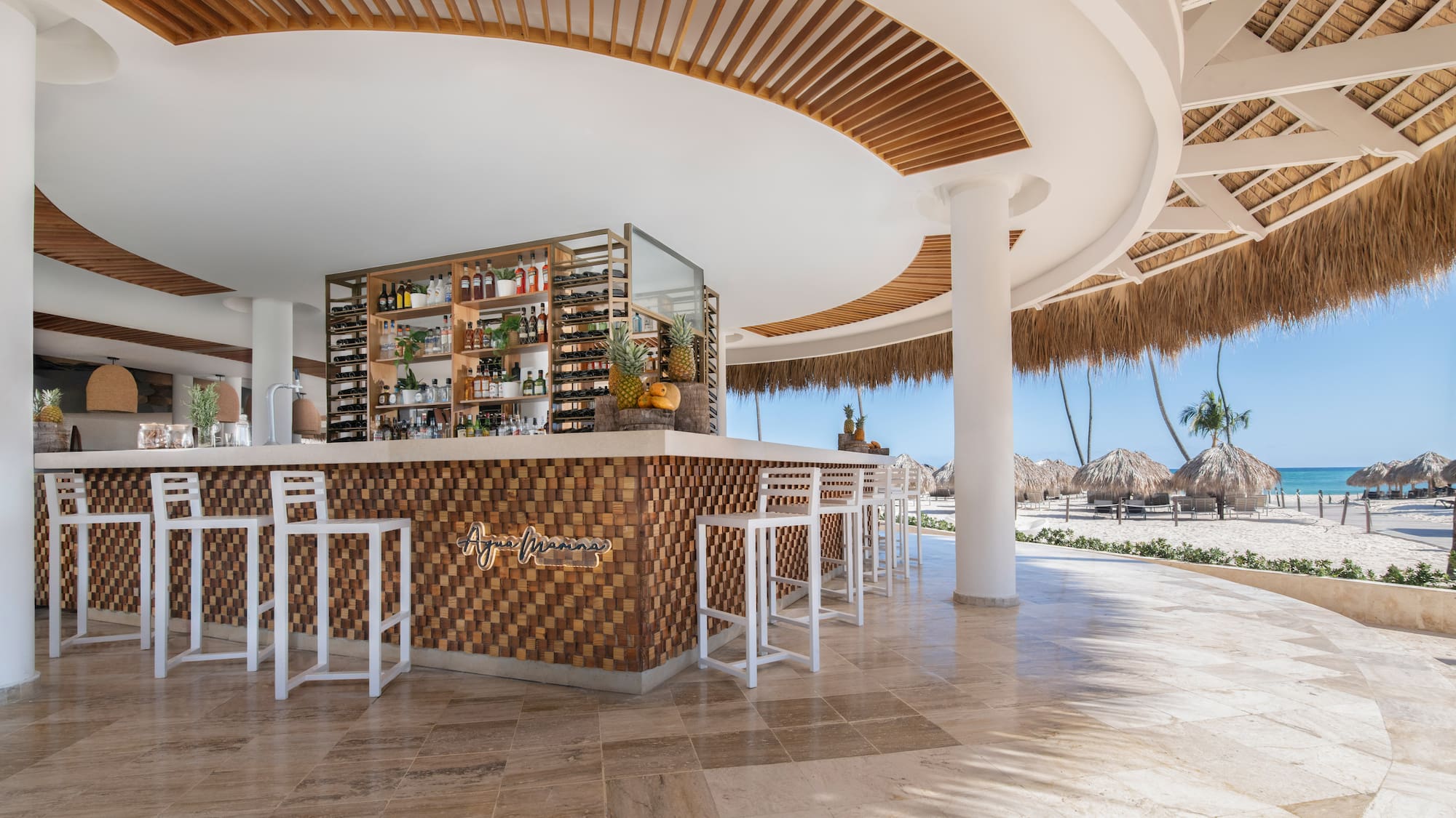 a bar with a shelf and chairs in a beach bar