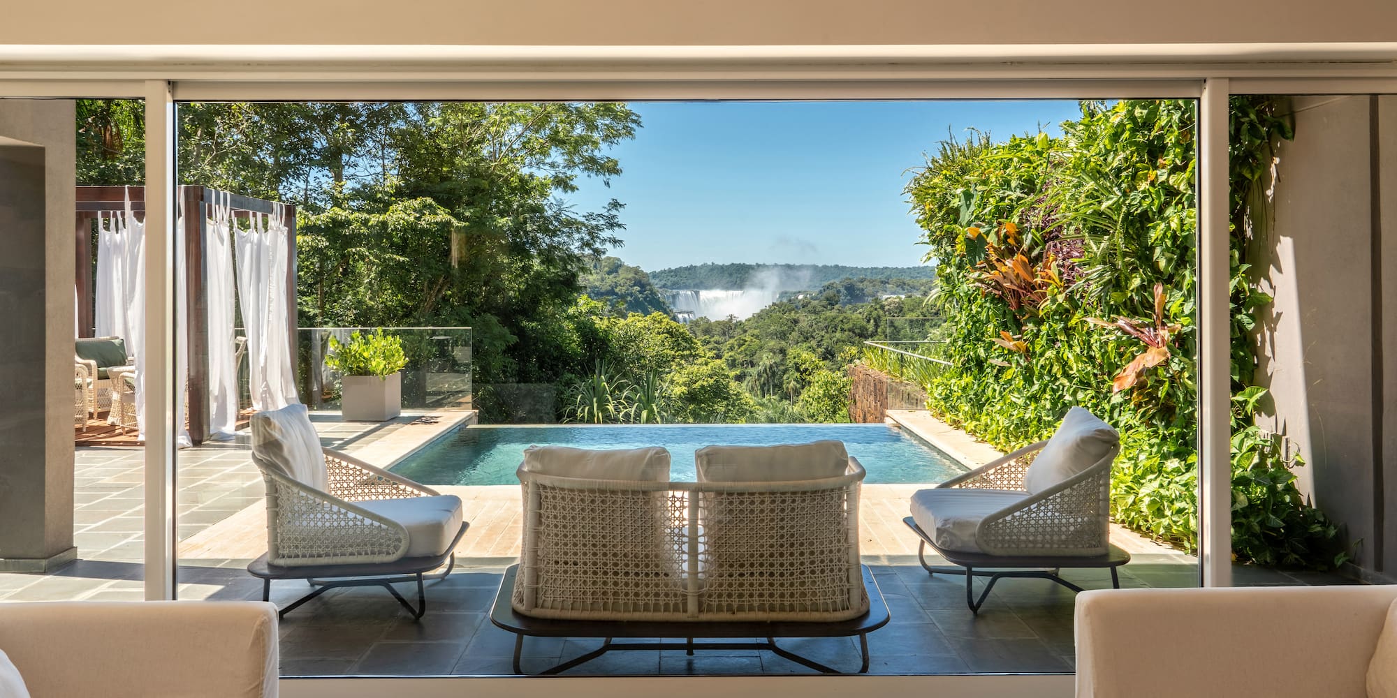 a room with a pool and chairs