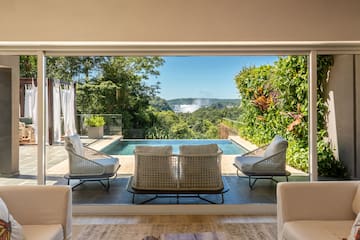 a room with a pool and chairs