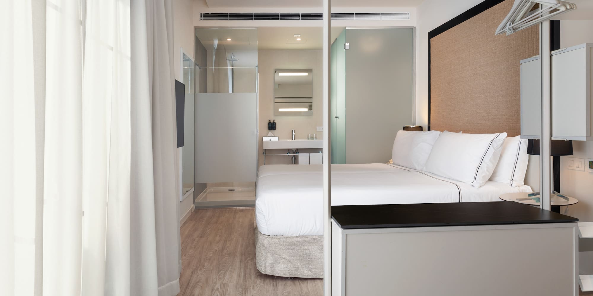 a bedroom with a bed and a shower