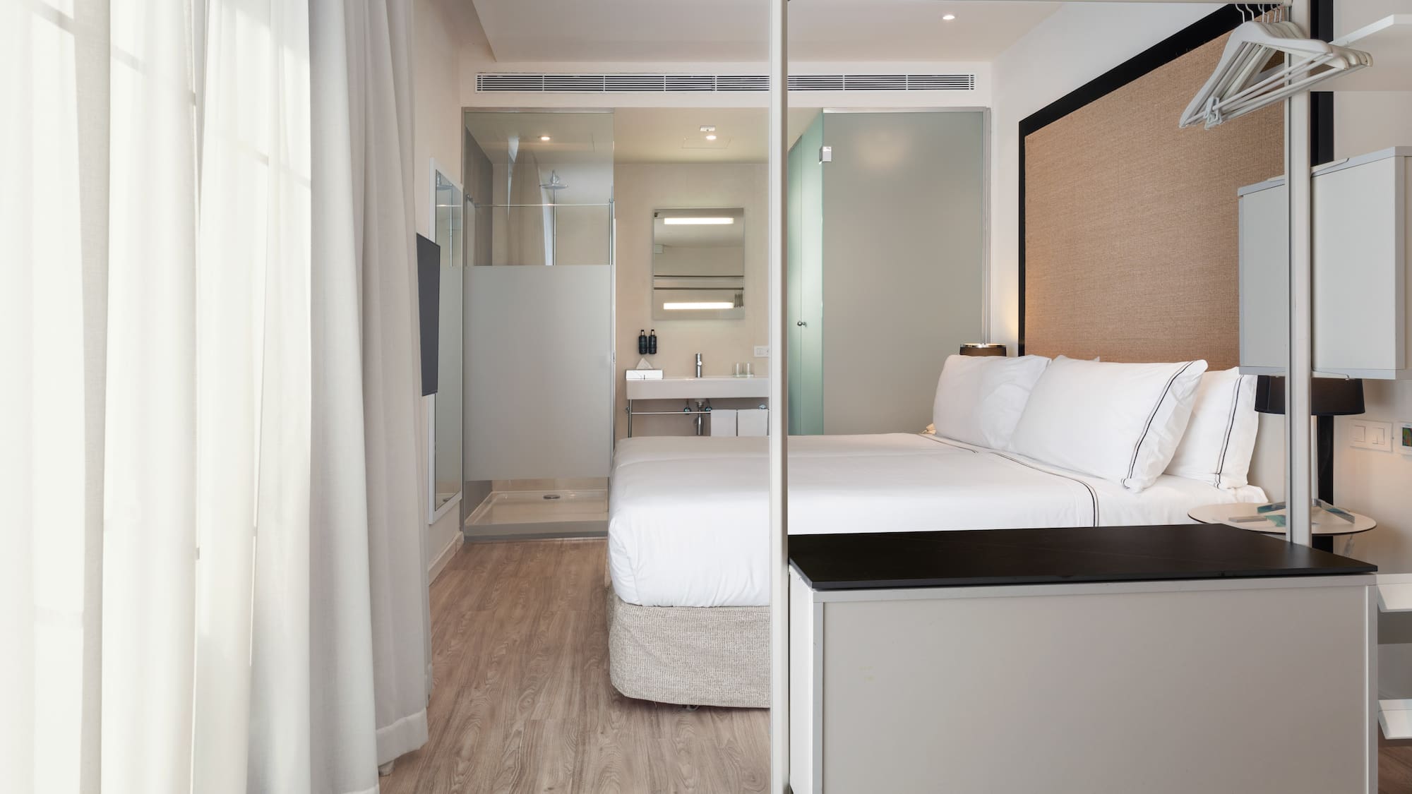 a bedroom with a bed and a shower