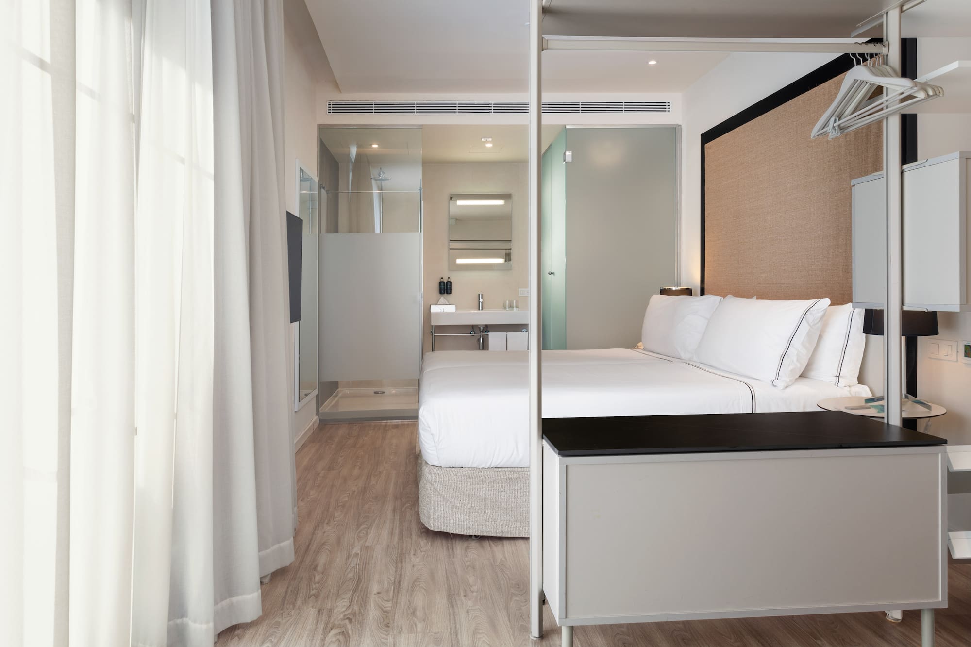 a bedroom with a bed and a shower