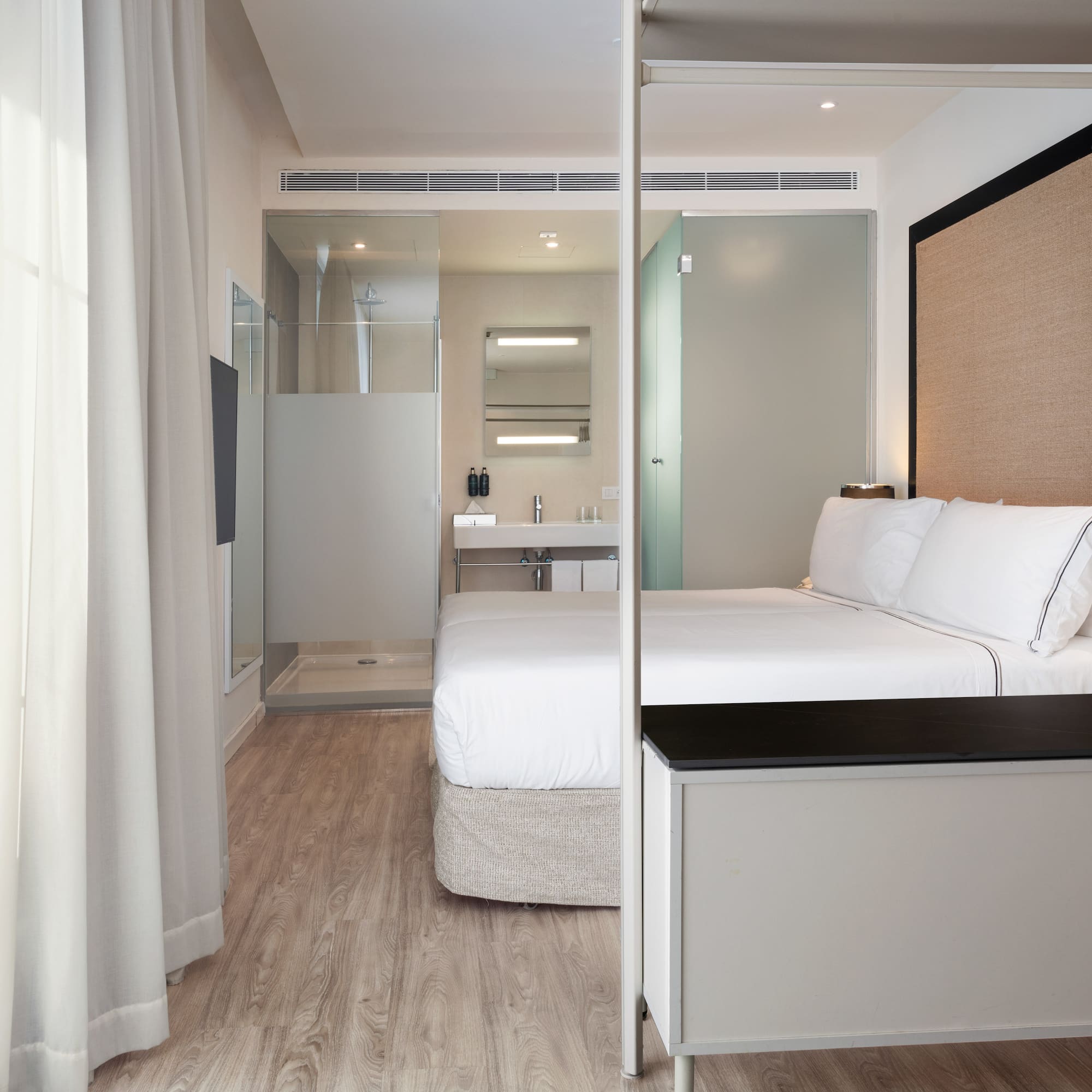 a bedroom with a bed and a shower