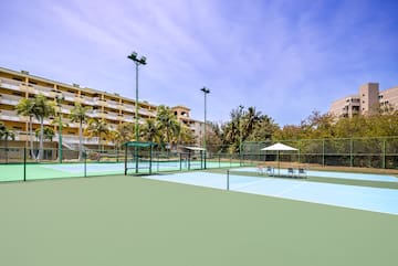 a tennis court with a building in the background