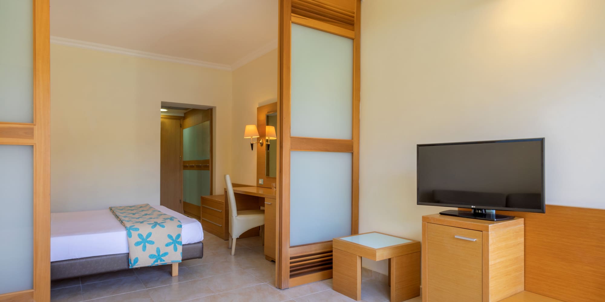 a room with a bed and a television