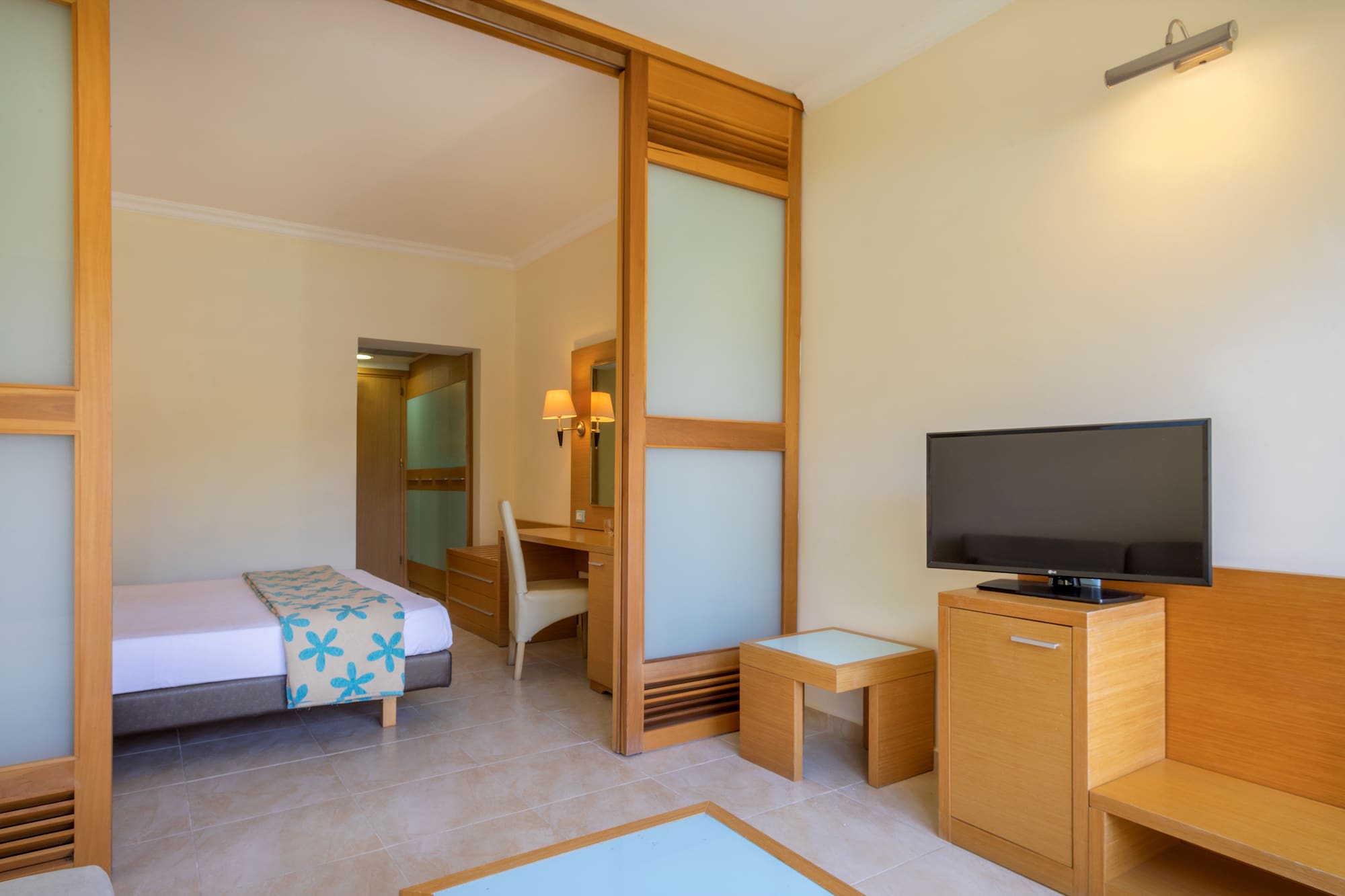 a room with a bed and a television