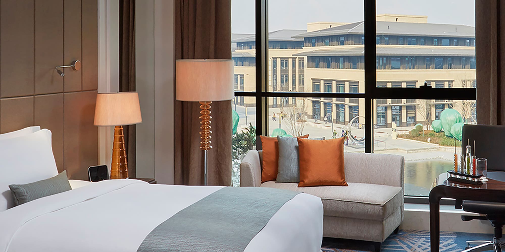 a hotel room with two beds and a chair