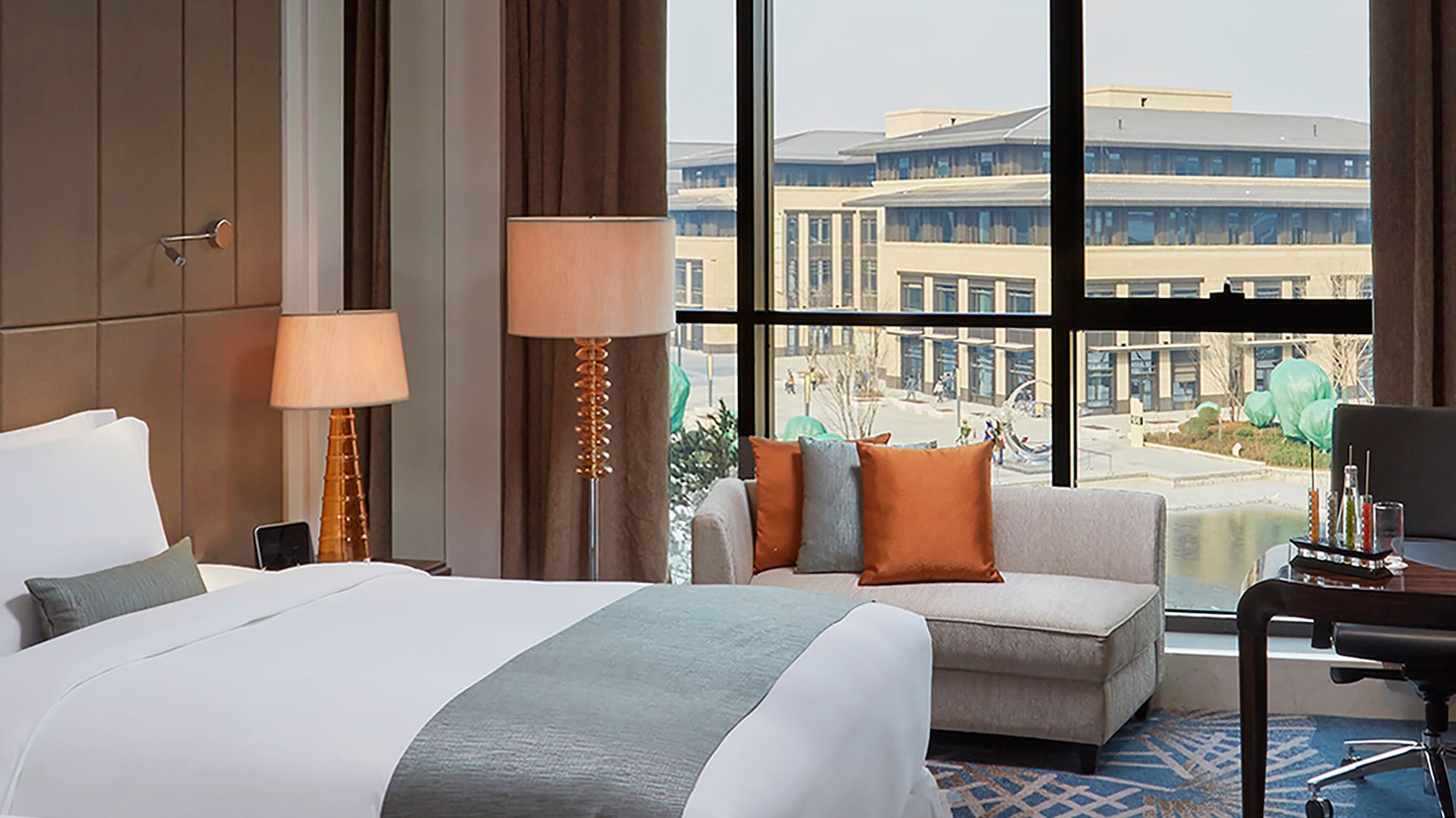 a hotel room with two beds and a chair