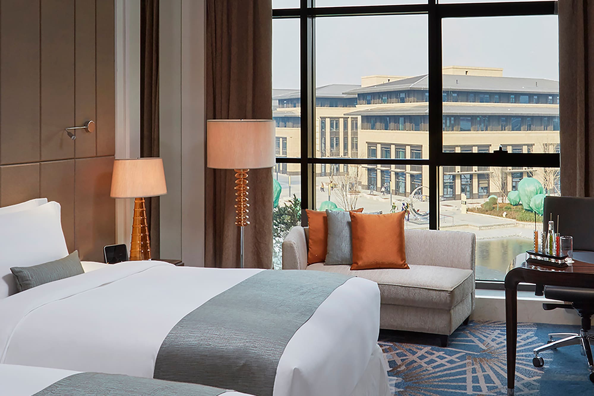 a hotel room with two beds and a chair