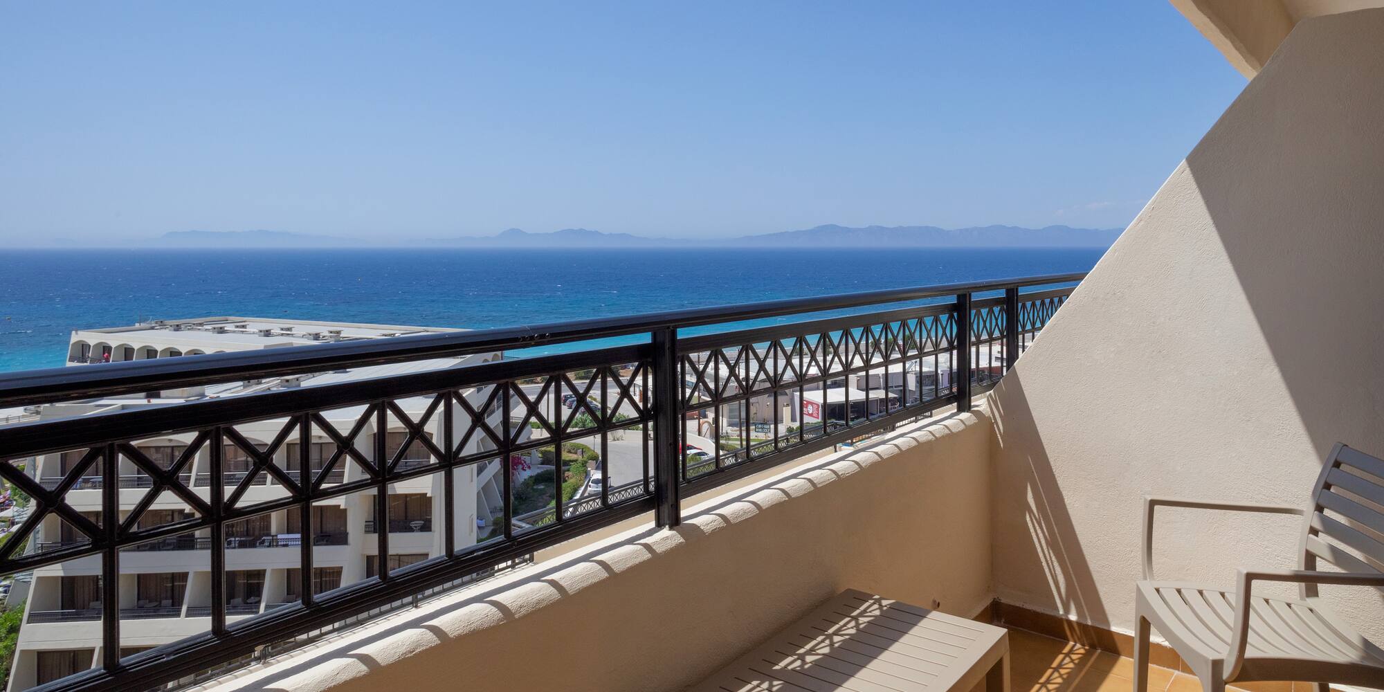 a balcony with a view of the ocean and a beach