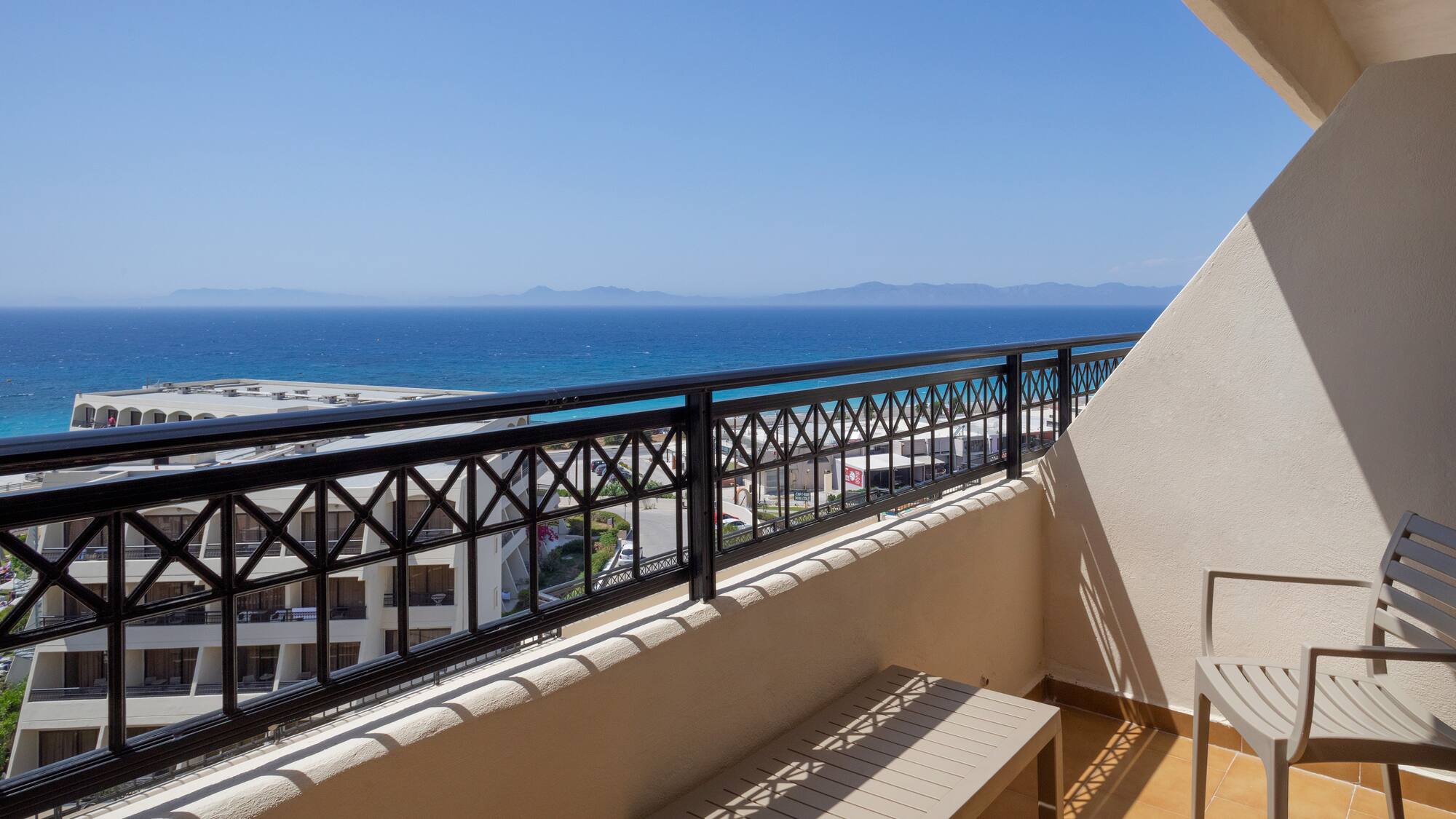 a balcony with a view of the ocean and a beach