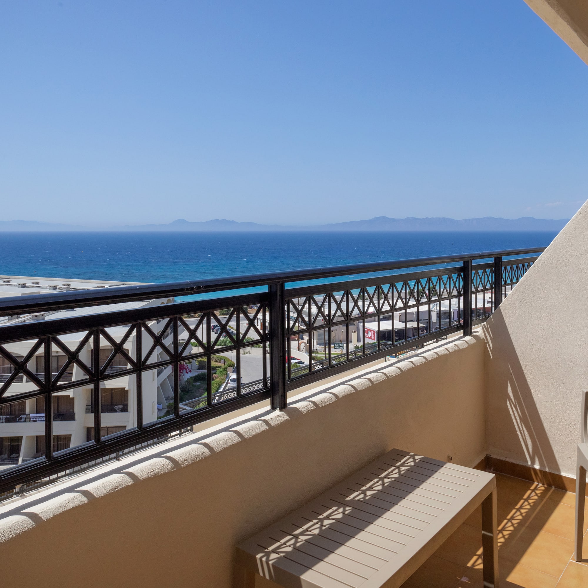 a balcony with a view of the ocean and a beach