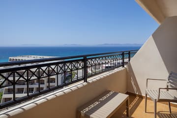 a balcony with a view of the ocean and a beach