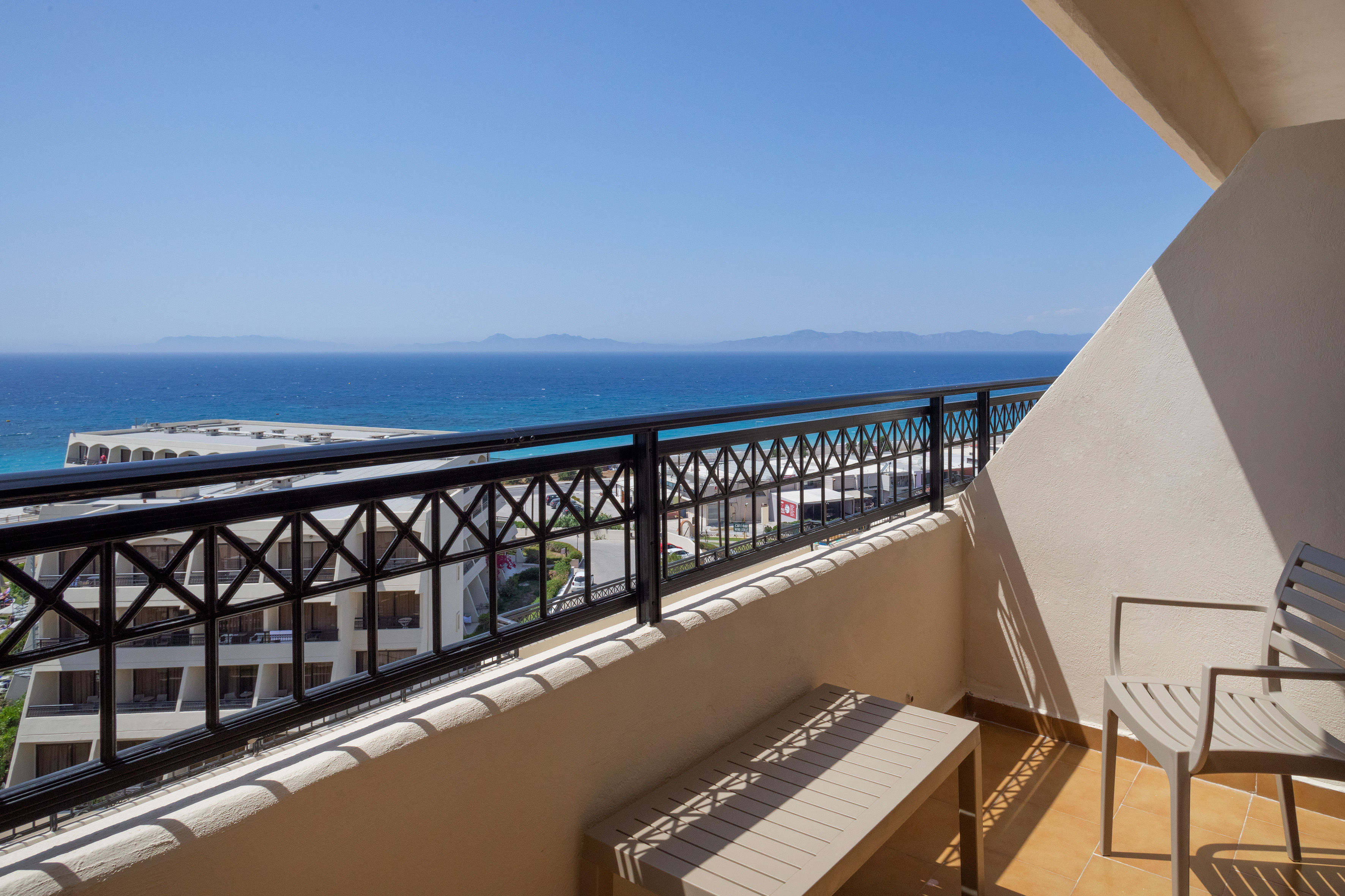 a balcony with a view of the ocean and a beach