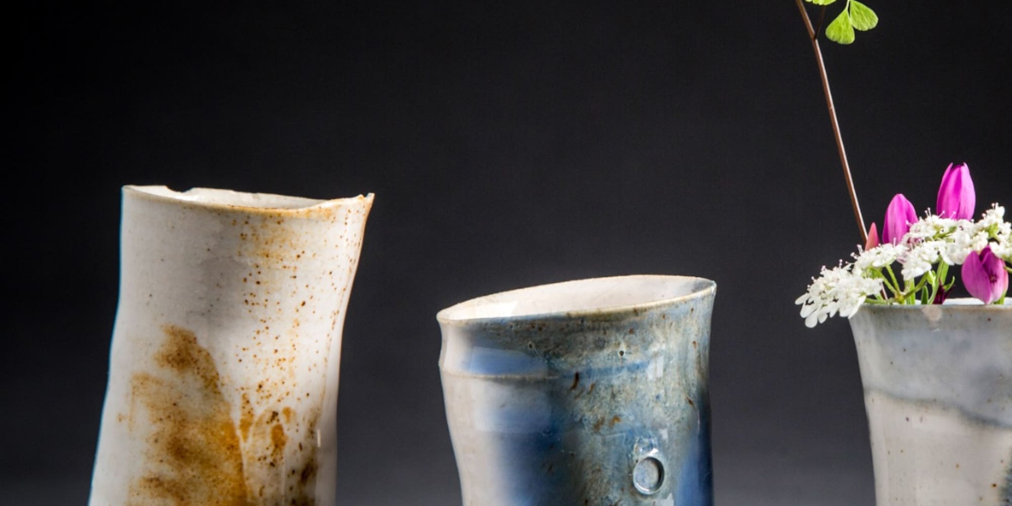 a group of vases with flowers