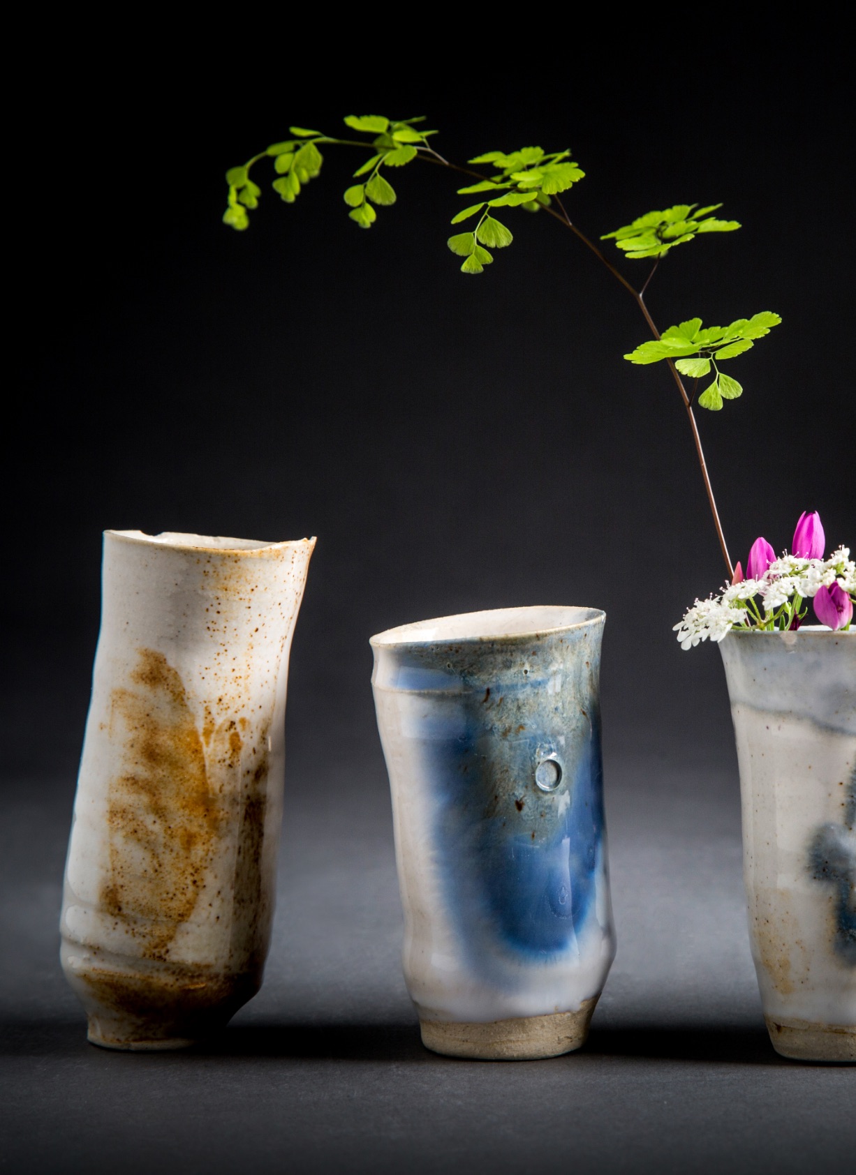 a group of vases with flowers