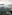 Two airplanes flying over green misty mountains and valleys.