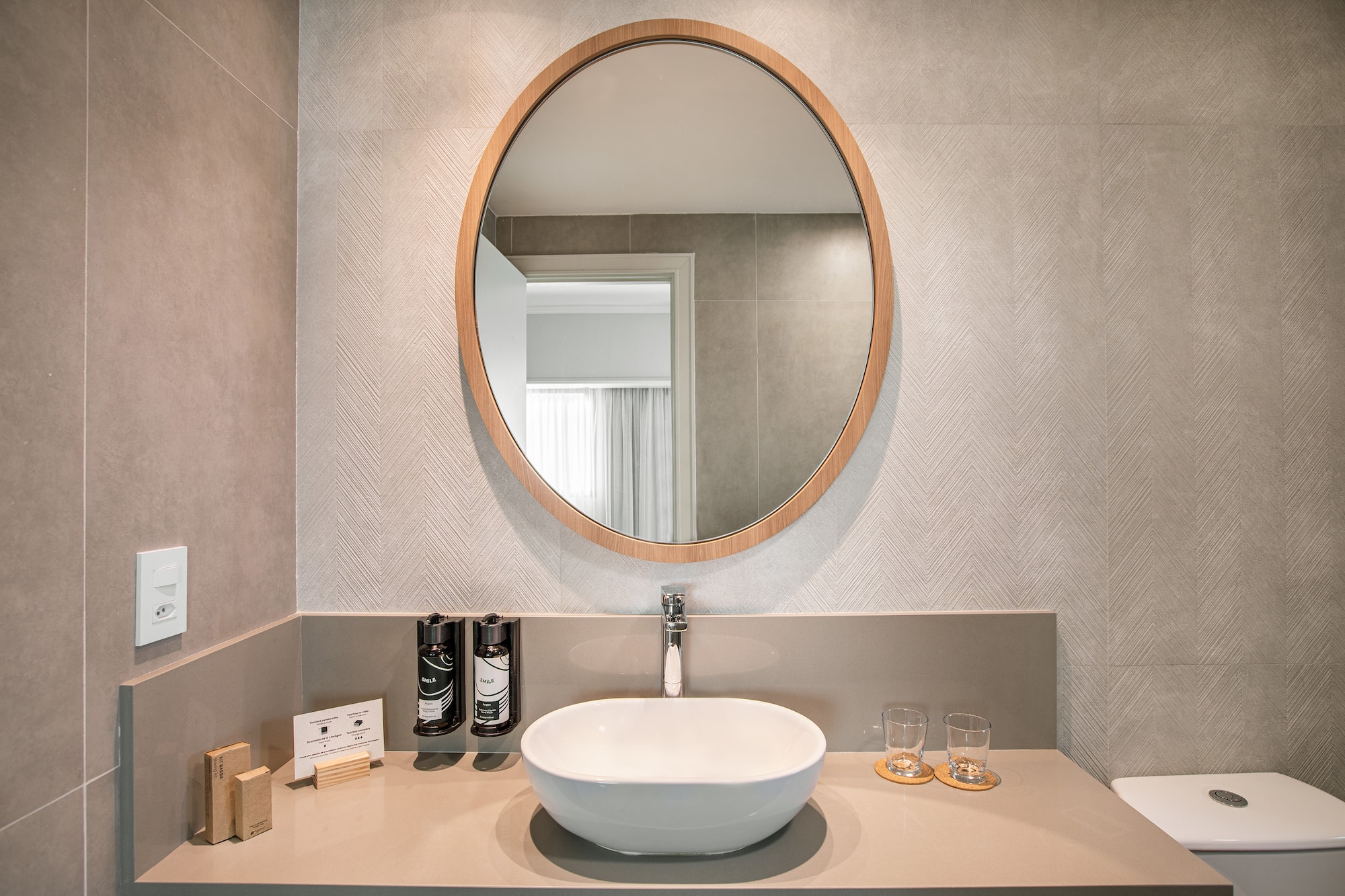 a bathroom with a round mirror