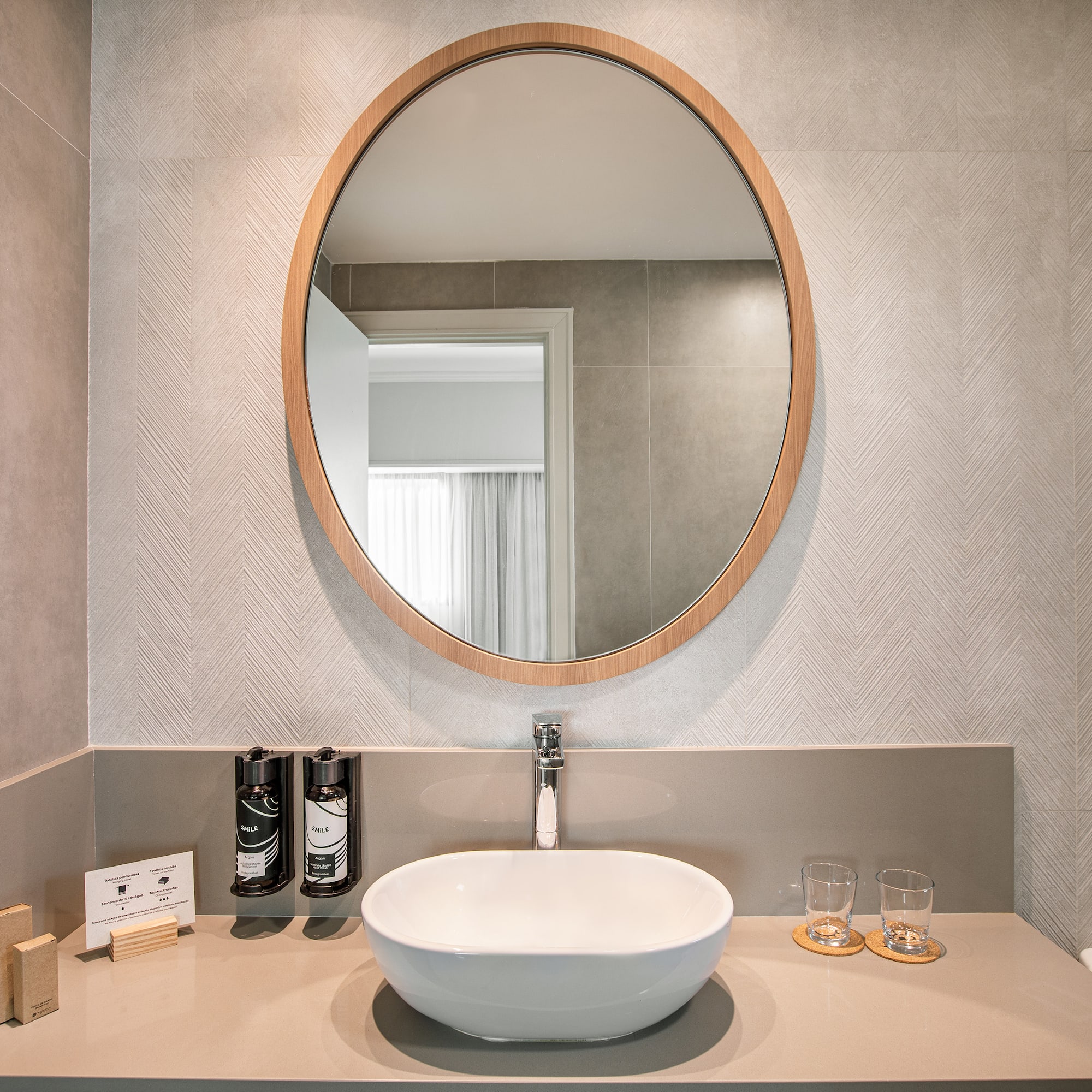 a bathroom with a round mirror