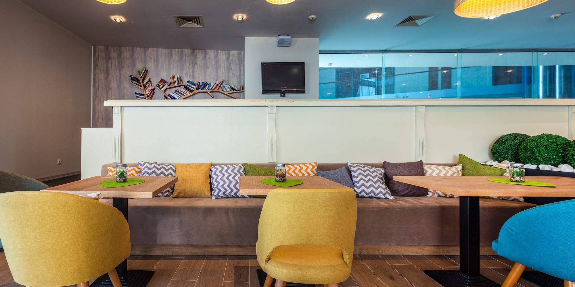 a room with a couch and tables and chairs