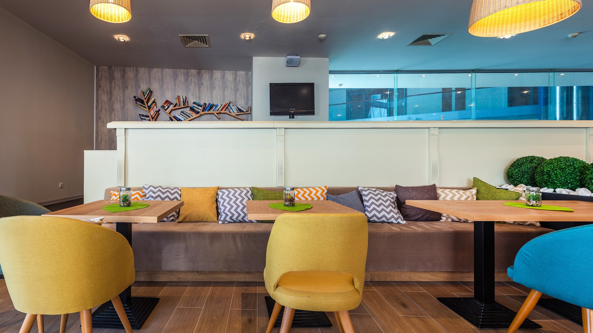 a room with a couch and tables and chairs