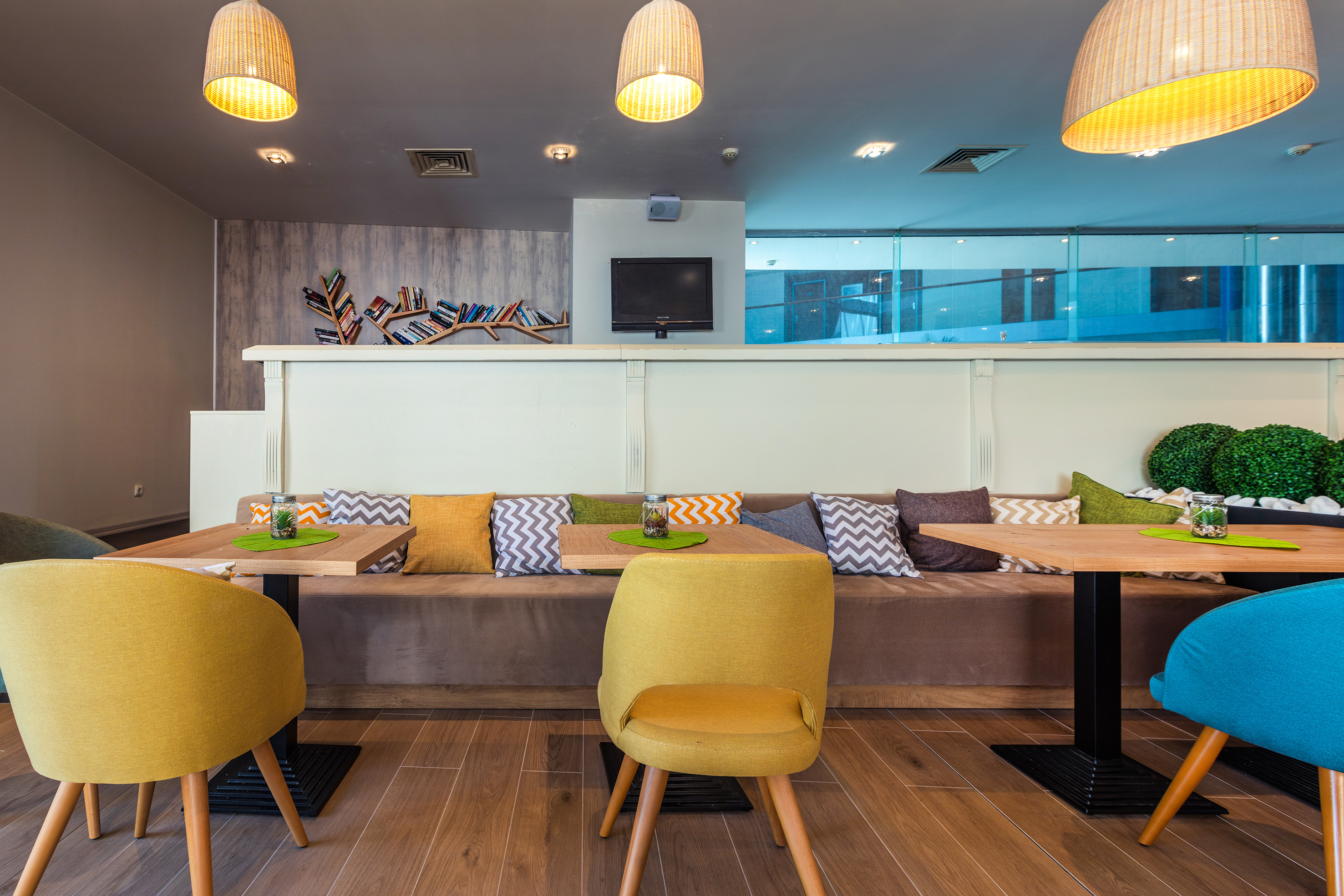 a room with a couch and tables and chairs