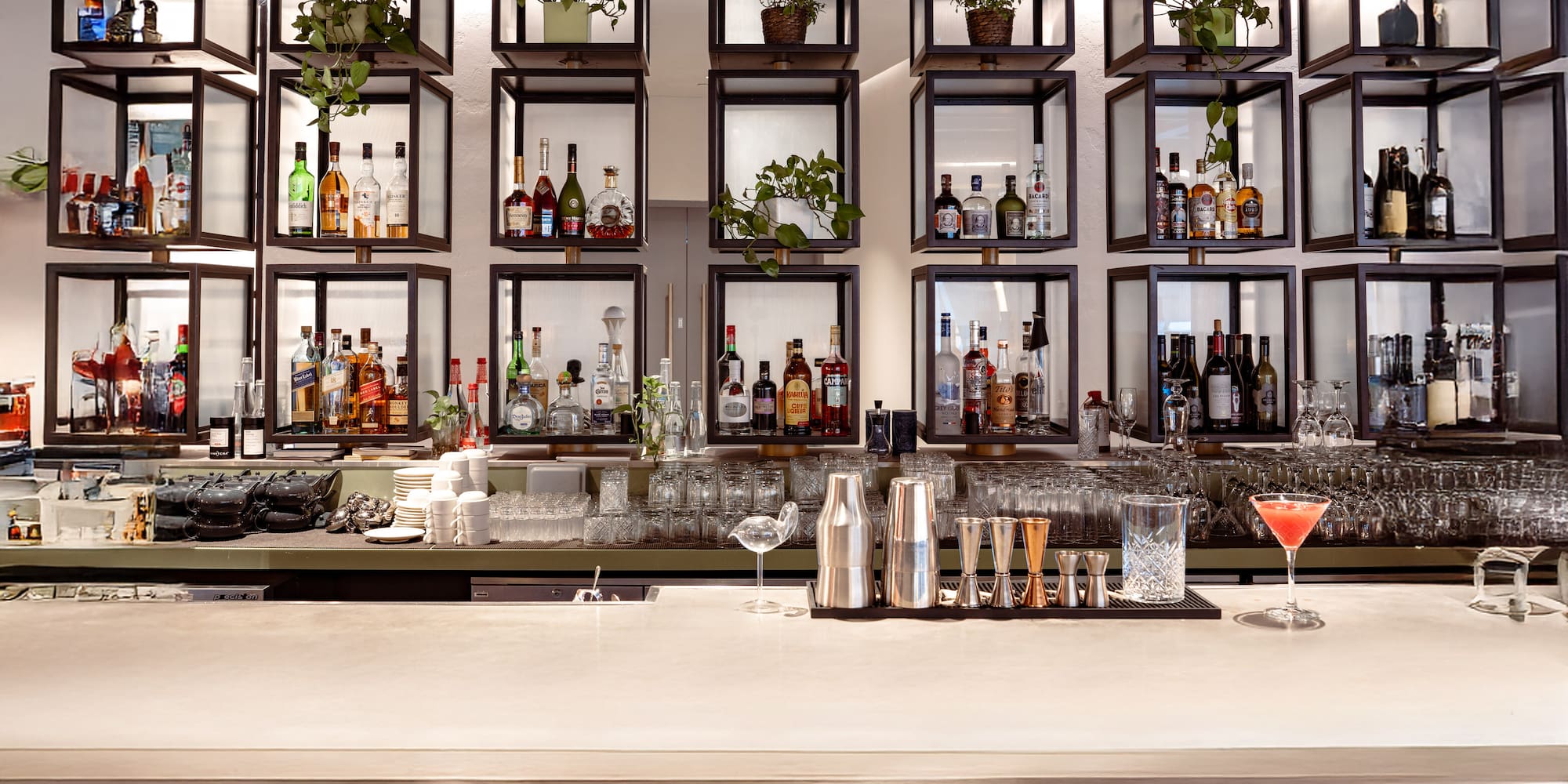 a bar with shelves of liquor and glasses