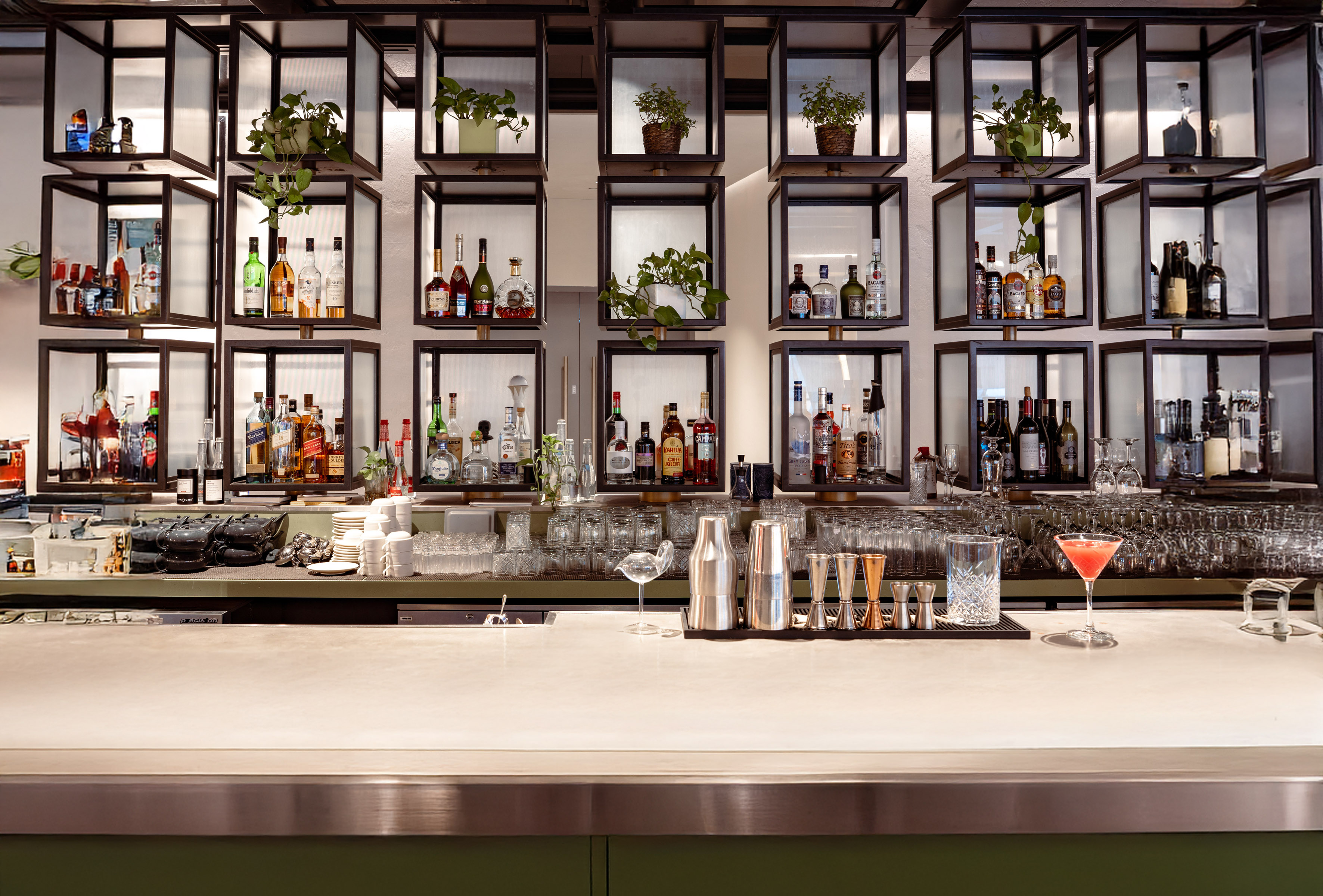 a bar with shelves of liquor and glasses