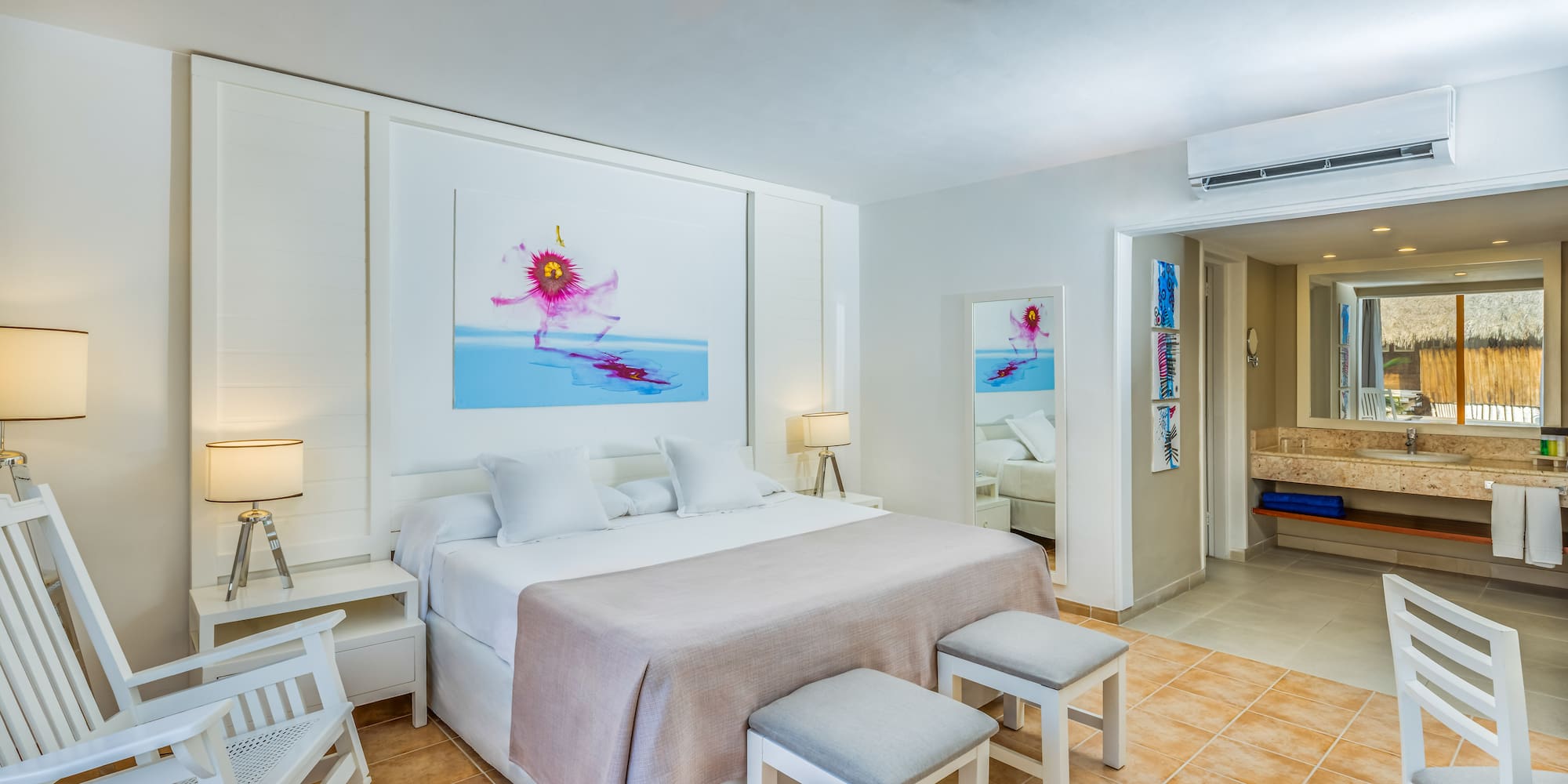 a bedroom with a bed and chairs