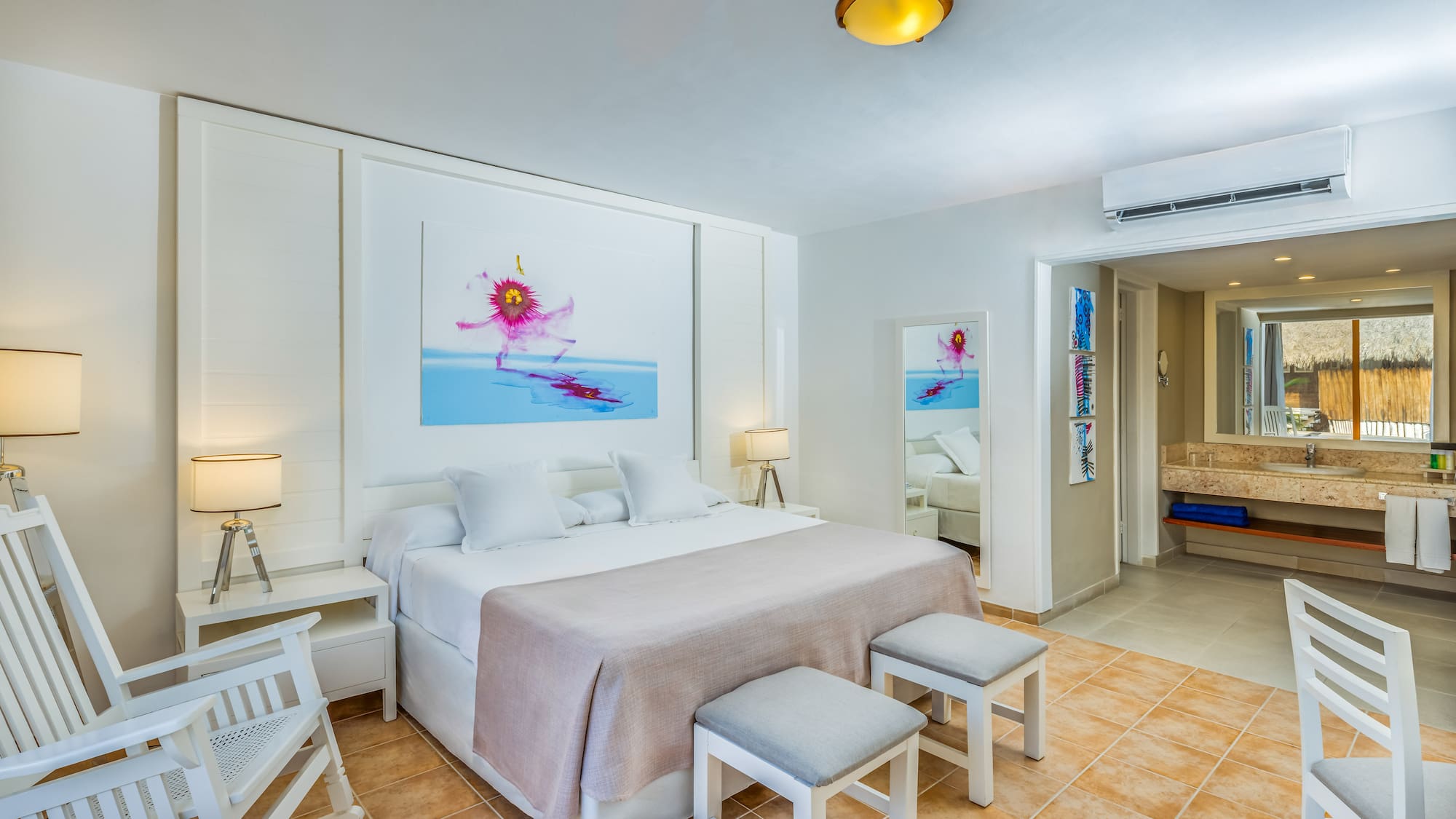 a bedroom with a bed and chairs