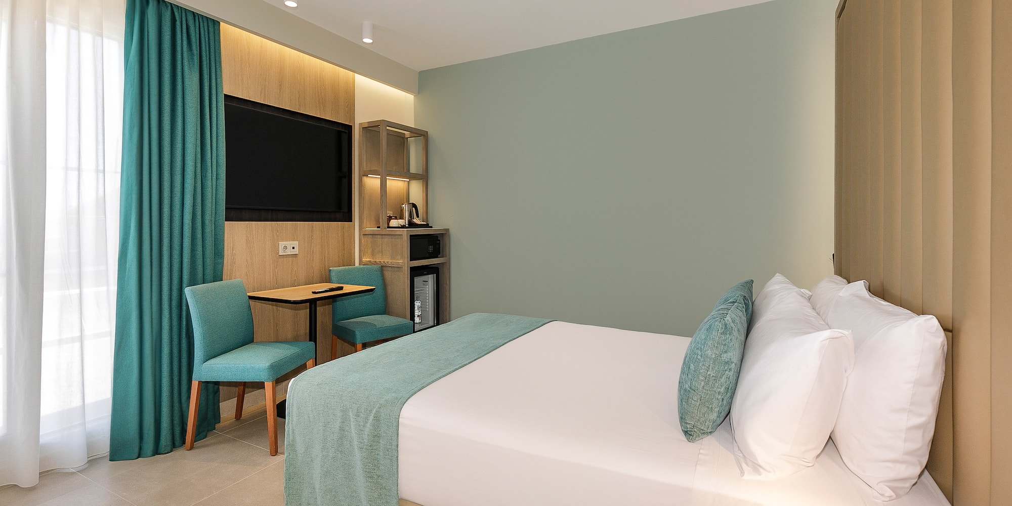 a room with a bed and a table and chair