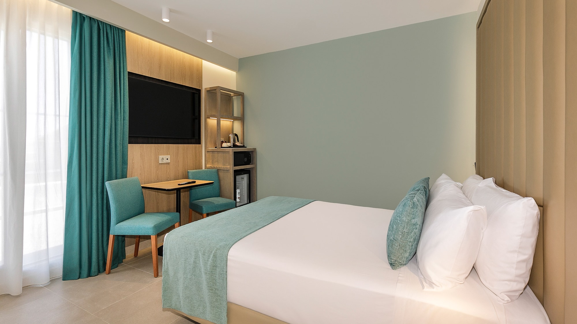 a room with a bed and a table and chair