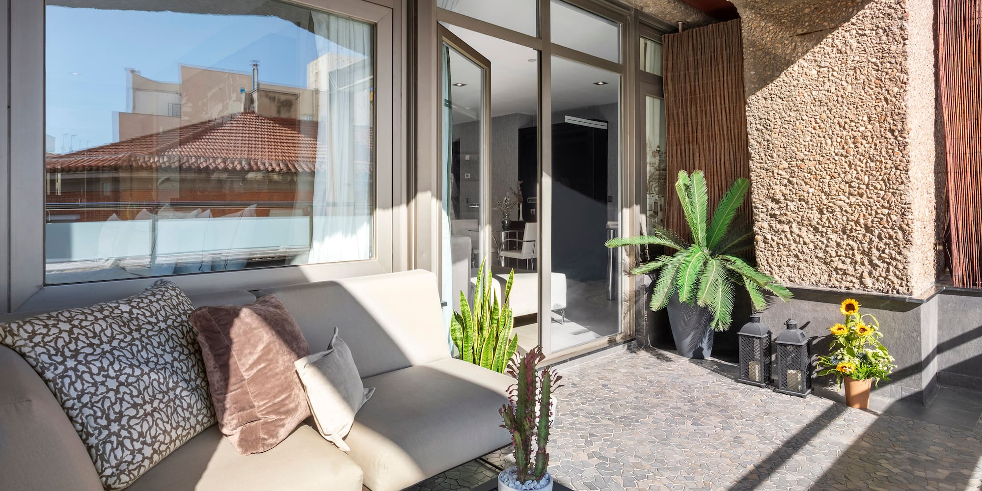 a couch and a table outside of a building