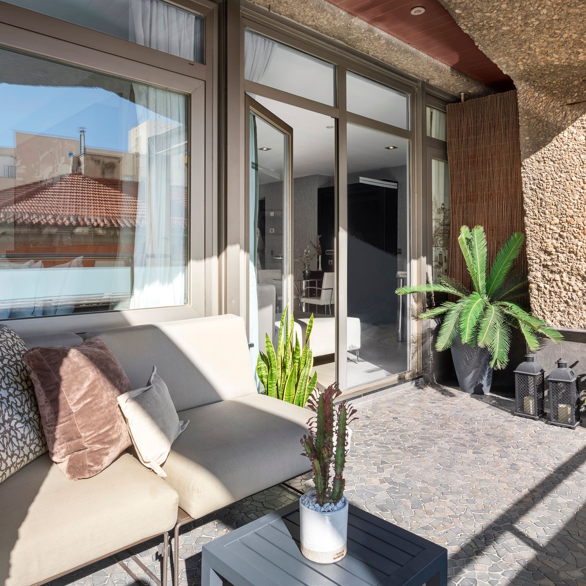 a couch and a table outside of a building