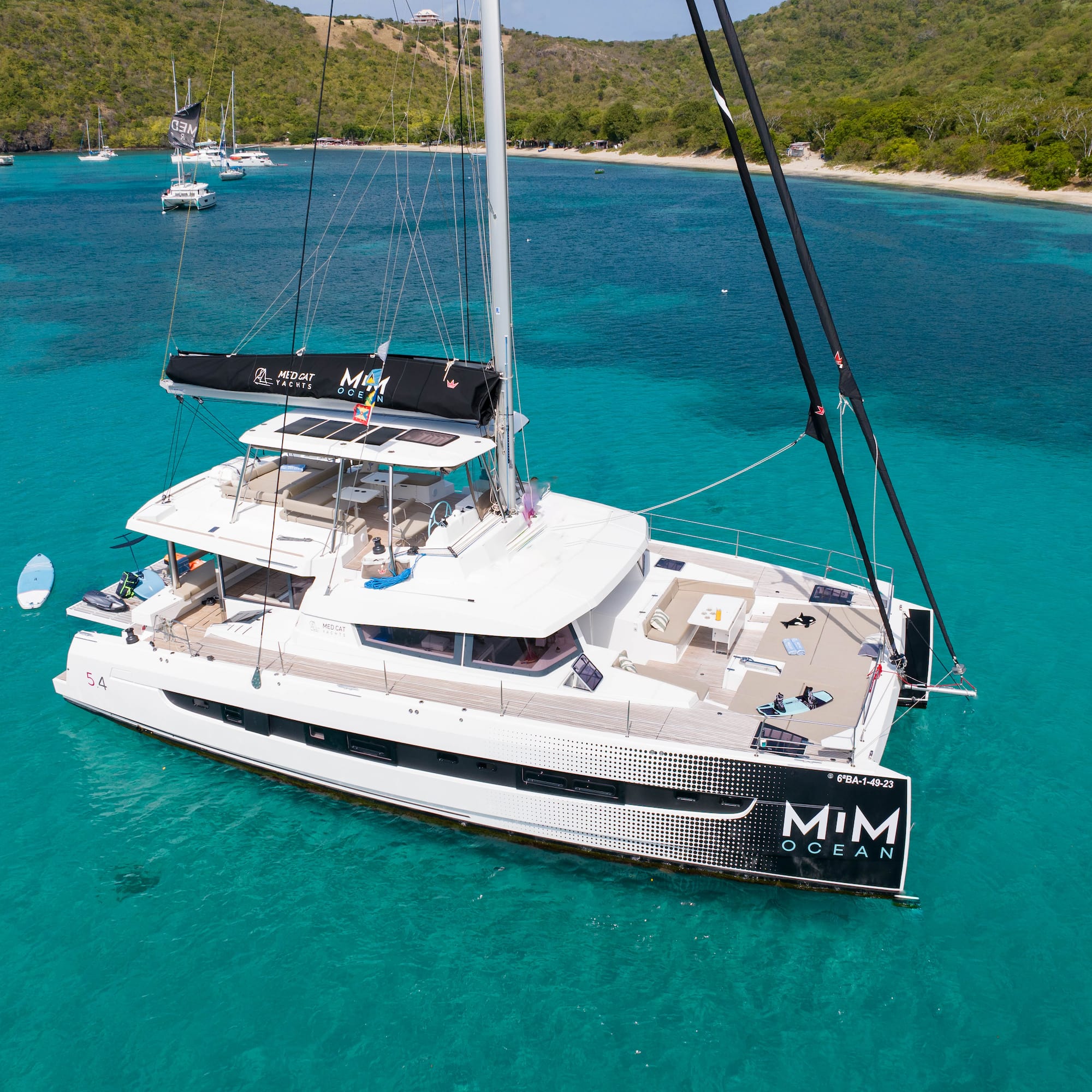 Luxury catamaran, MIM OCEAN, in vibrant tropical turquoise waters.