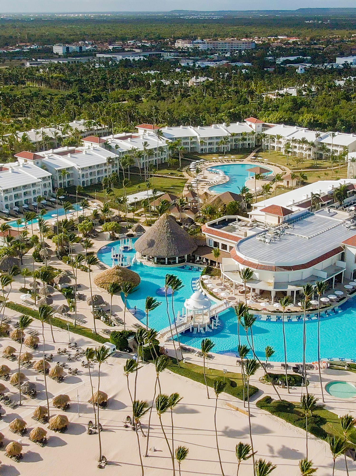a large resort with a pool and palm trees
