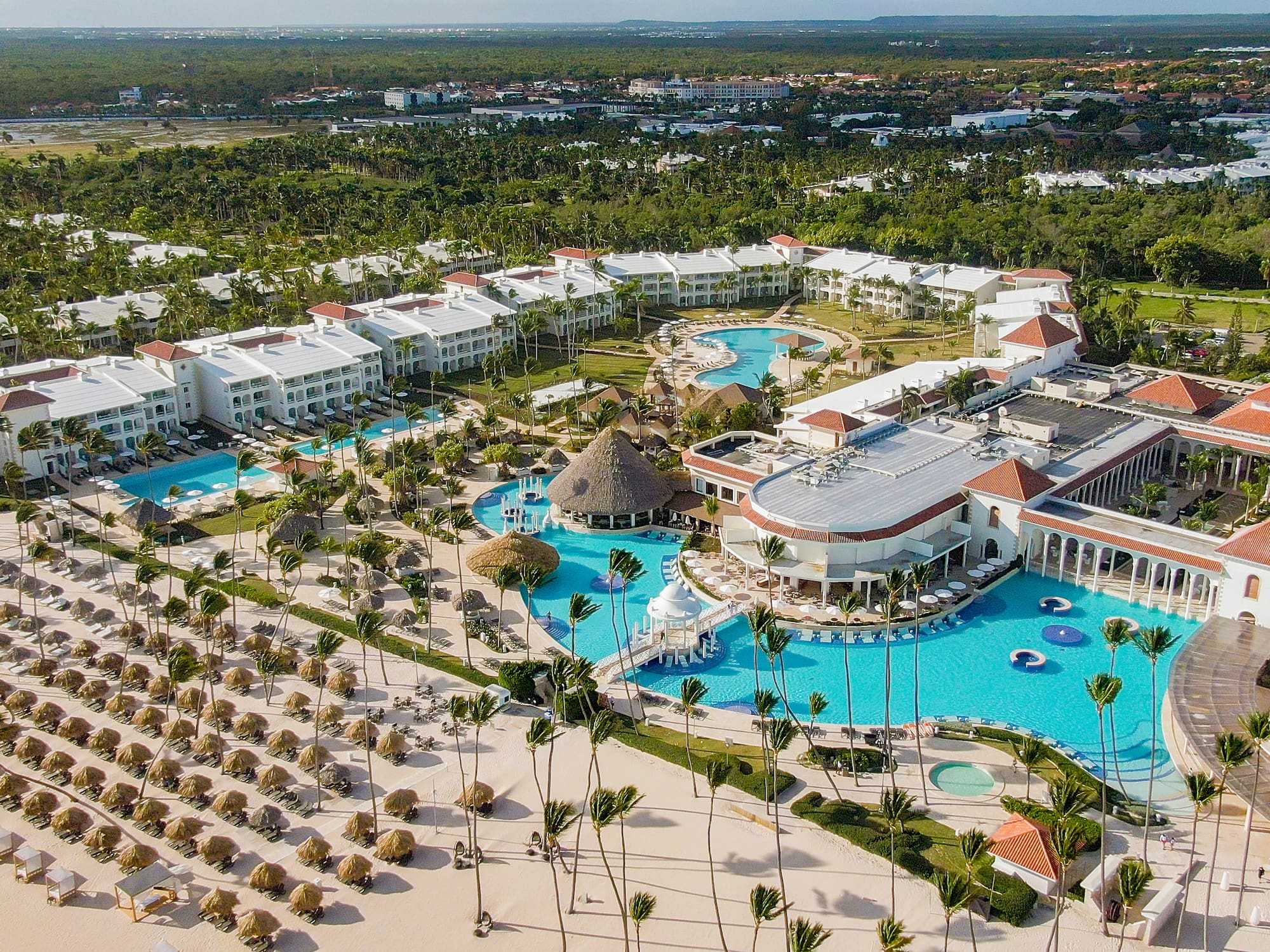 a large resort with a pool and palm trees