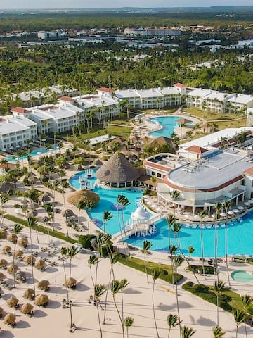 a large resort with a pool and palm trees