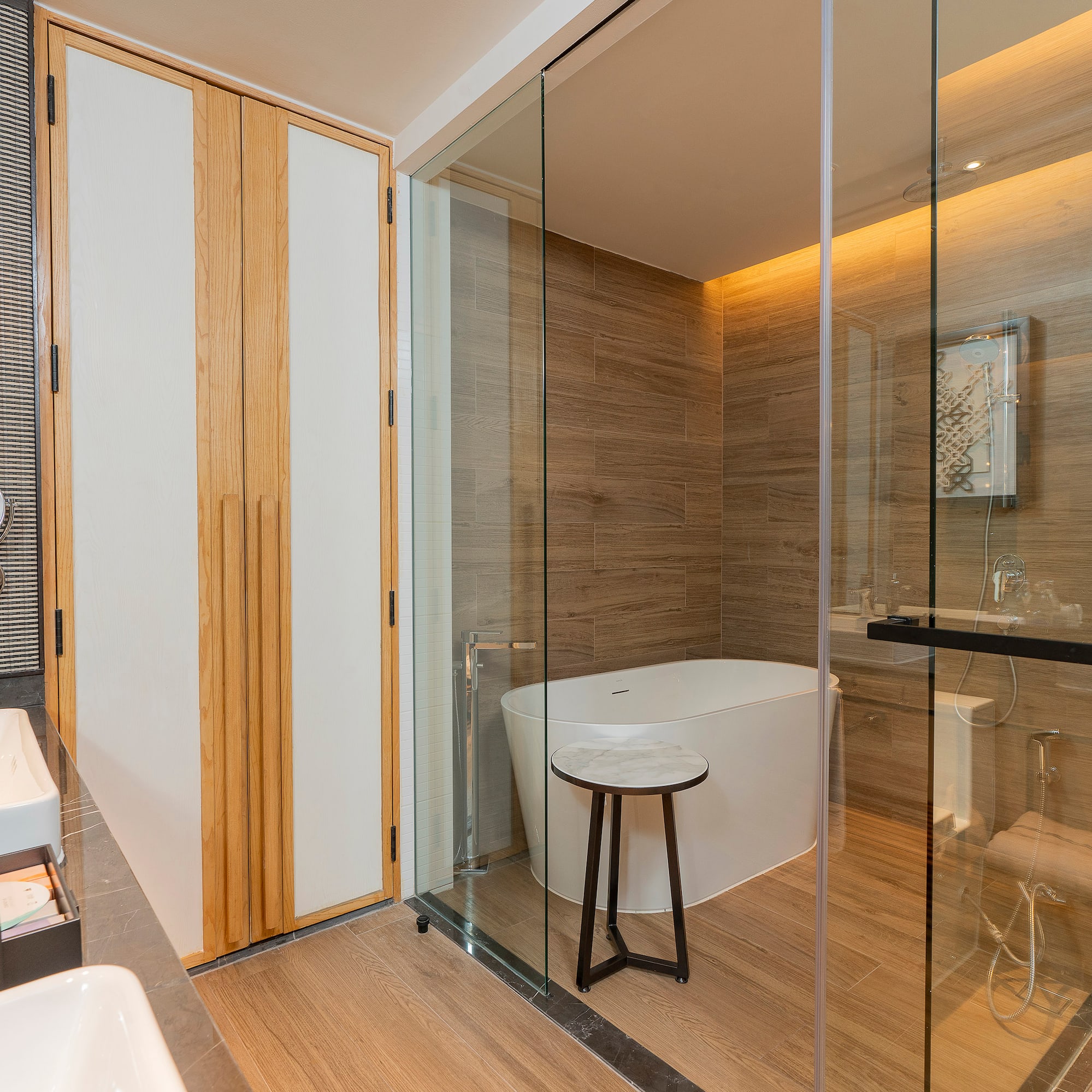 a bathroom with a glass shower door and a tub