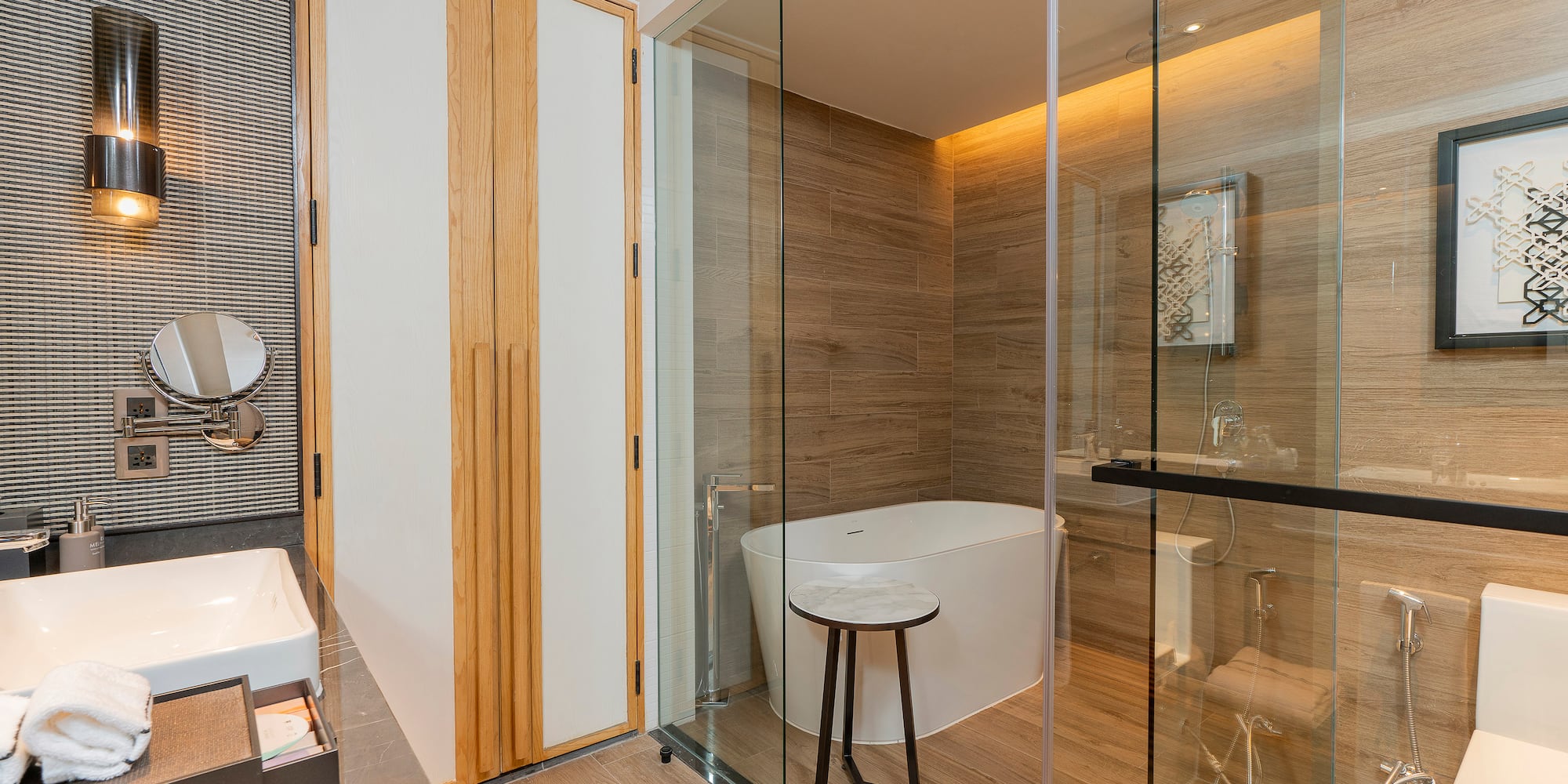 a bathroom with a glass shower door and a tub