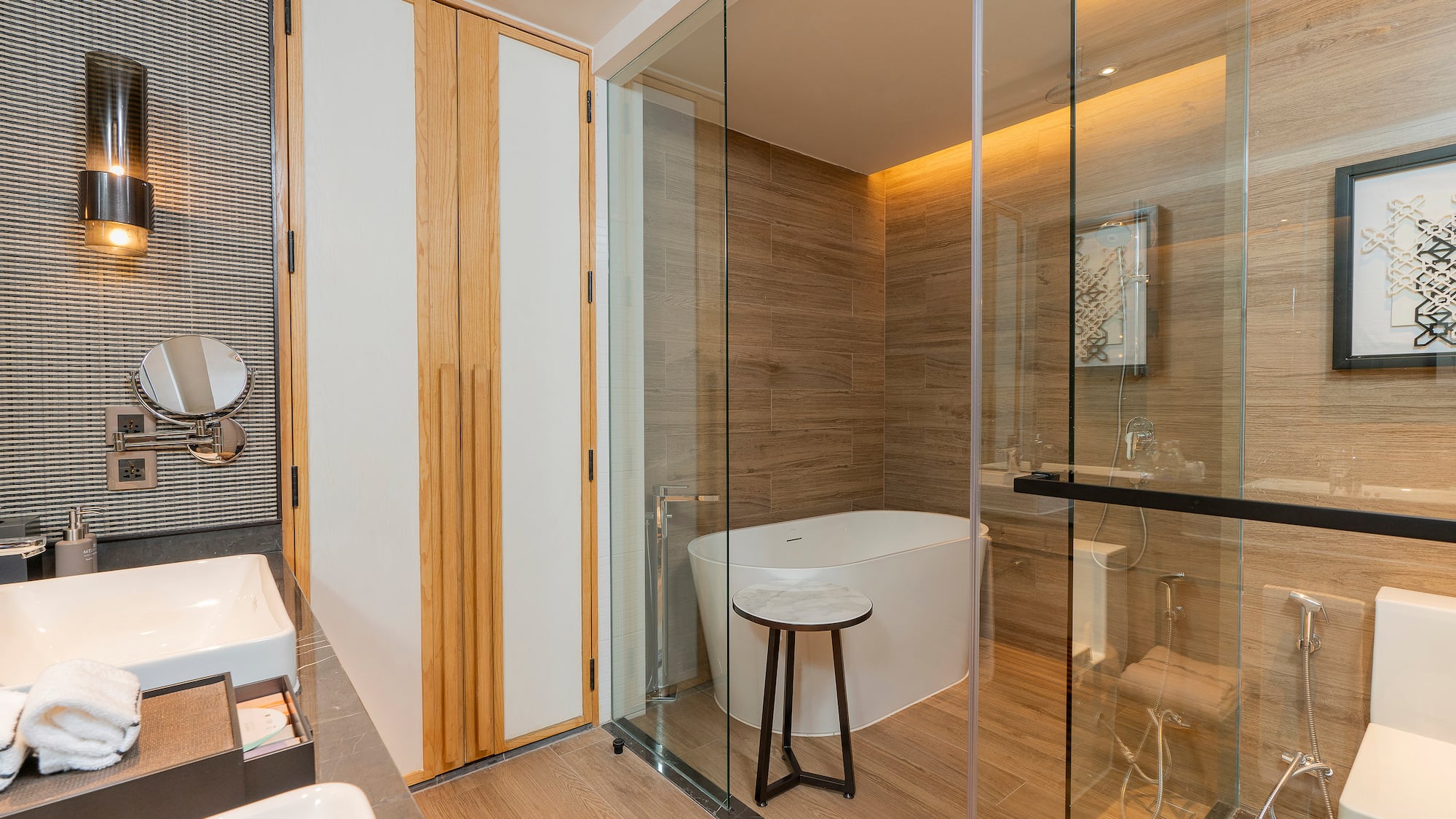 a bathroom with a glass shower door and a tub