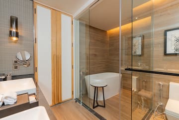 a bathroom with a glass shower door and a tub
