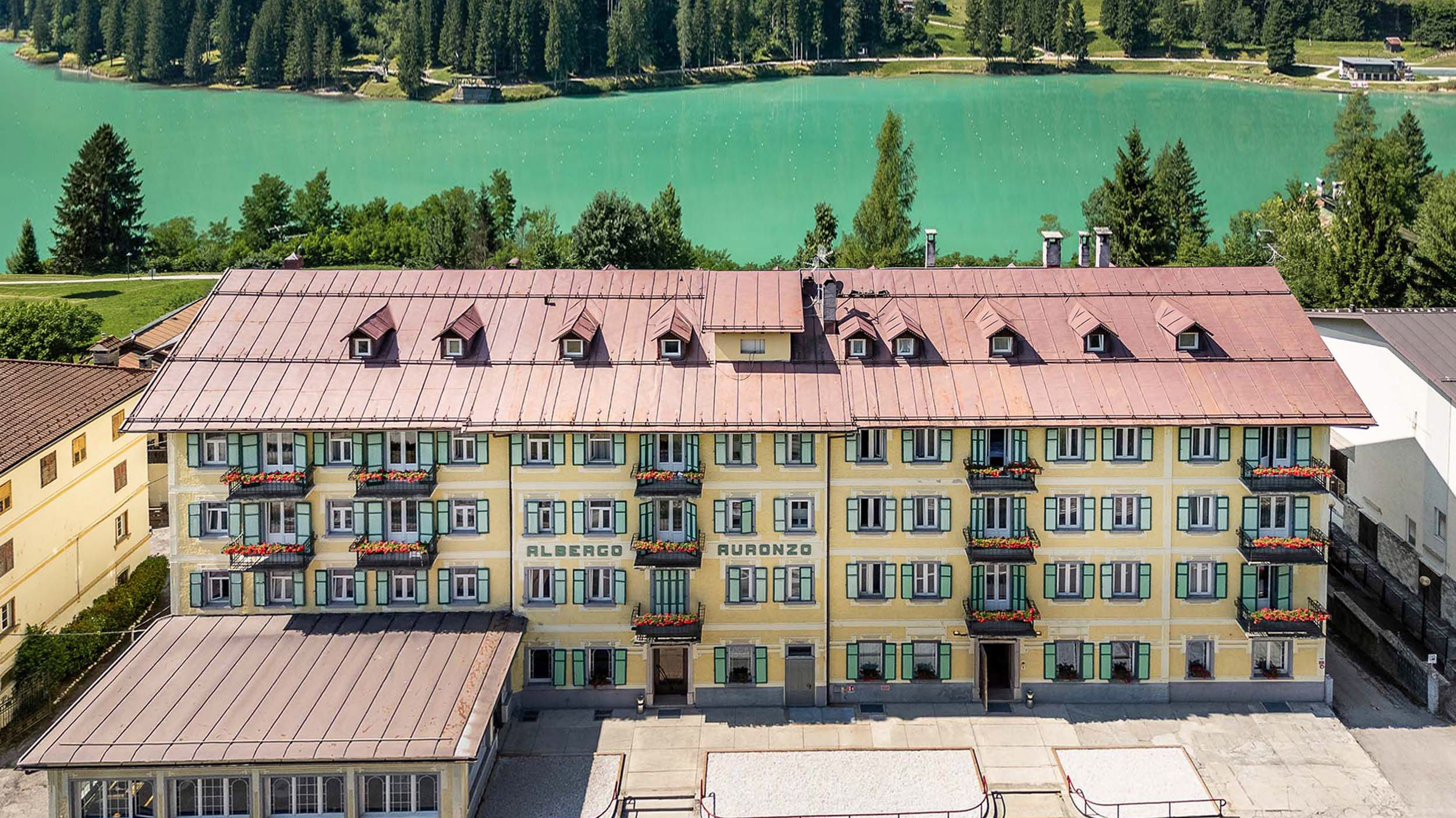 Albergo Auronzo hotel by turquoise Lake Santa Caterina in the Dolomites.
