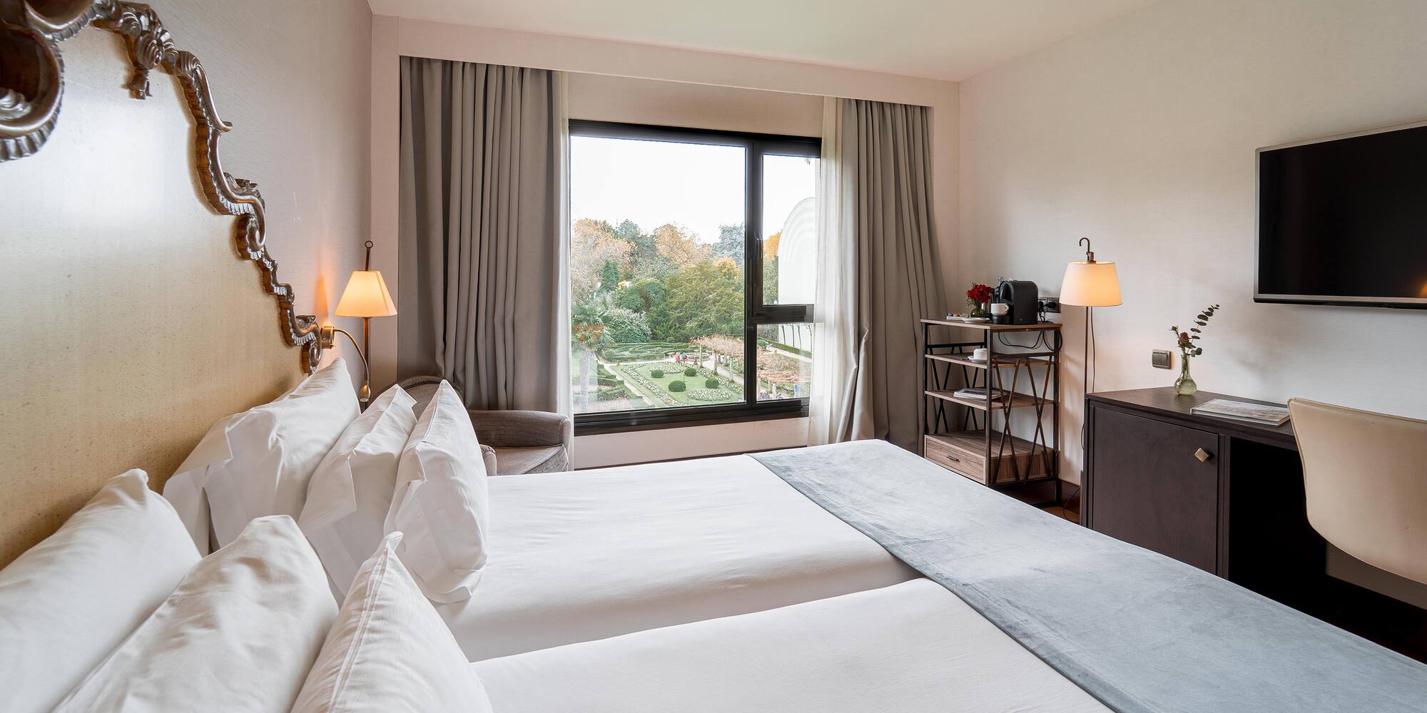 a room with two beds and a window