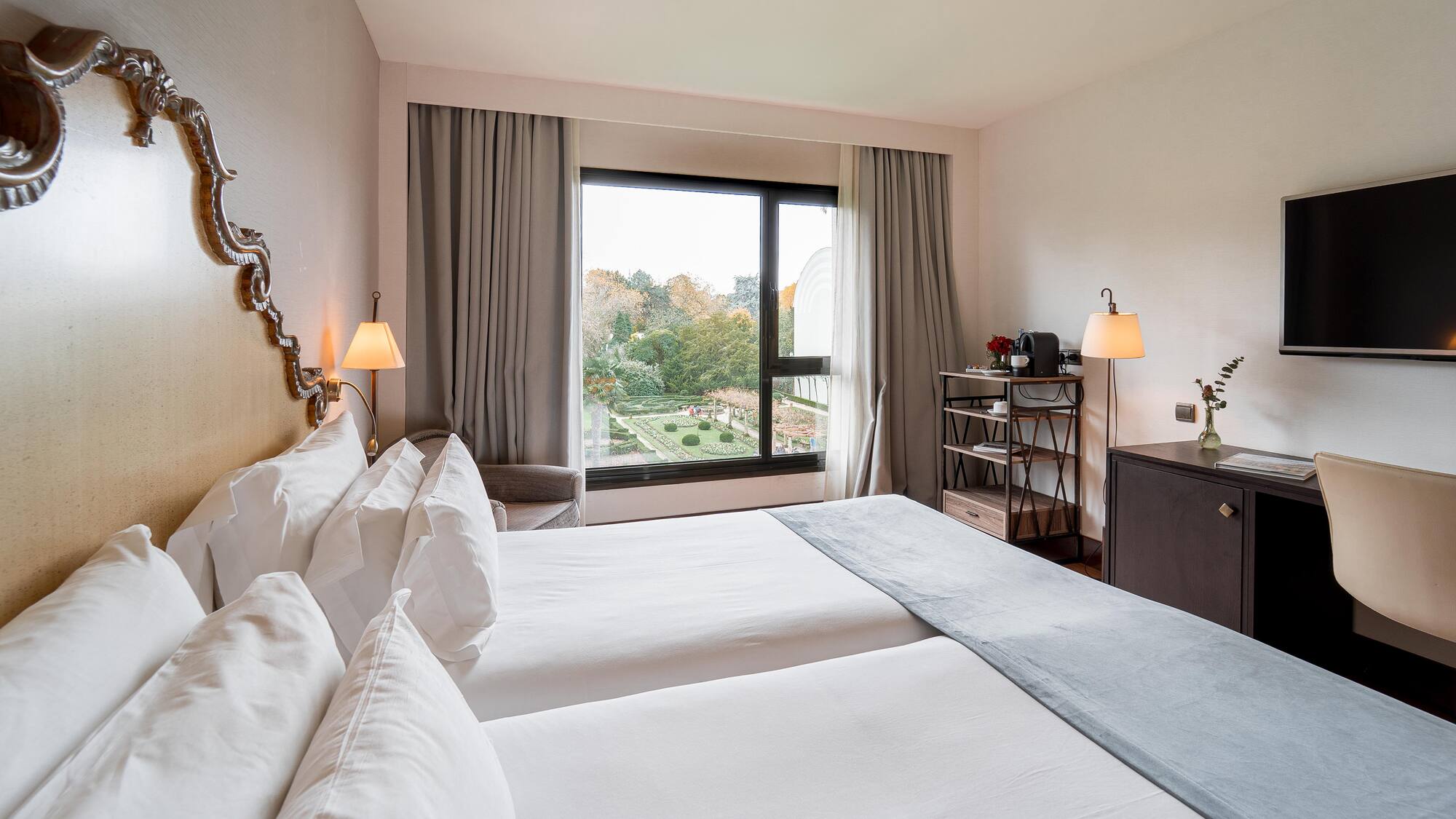 a room with two beds and a window