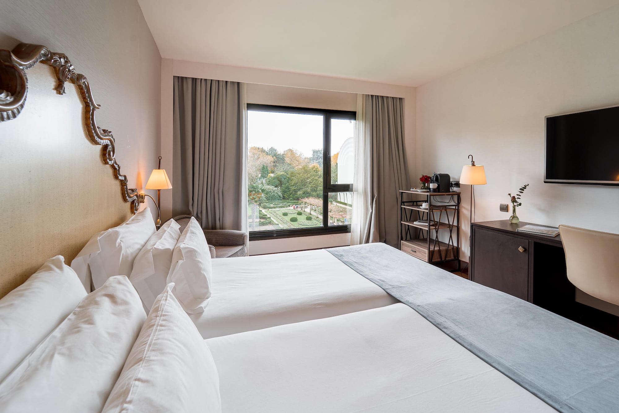 a room with two beds and a window