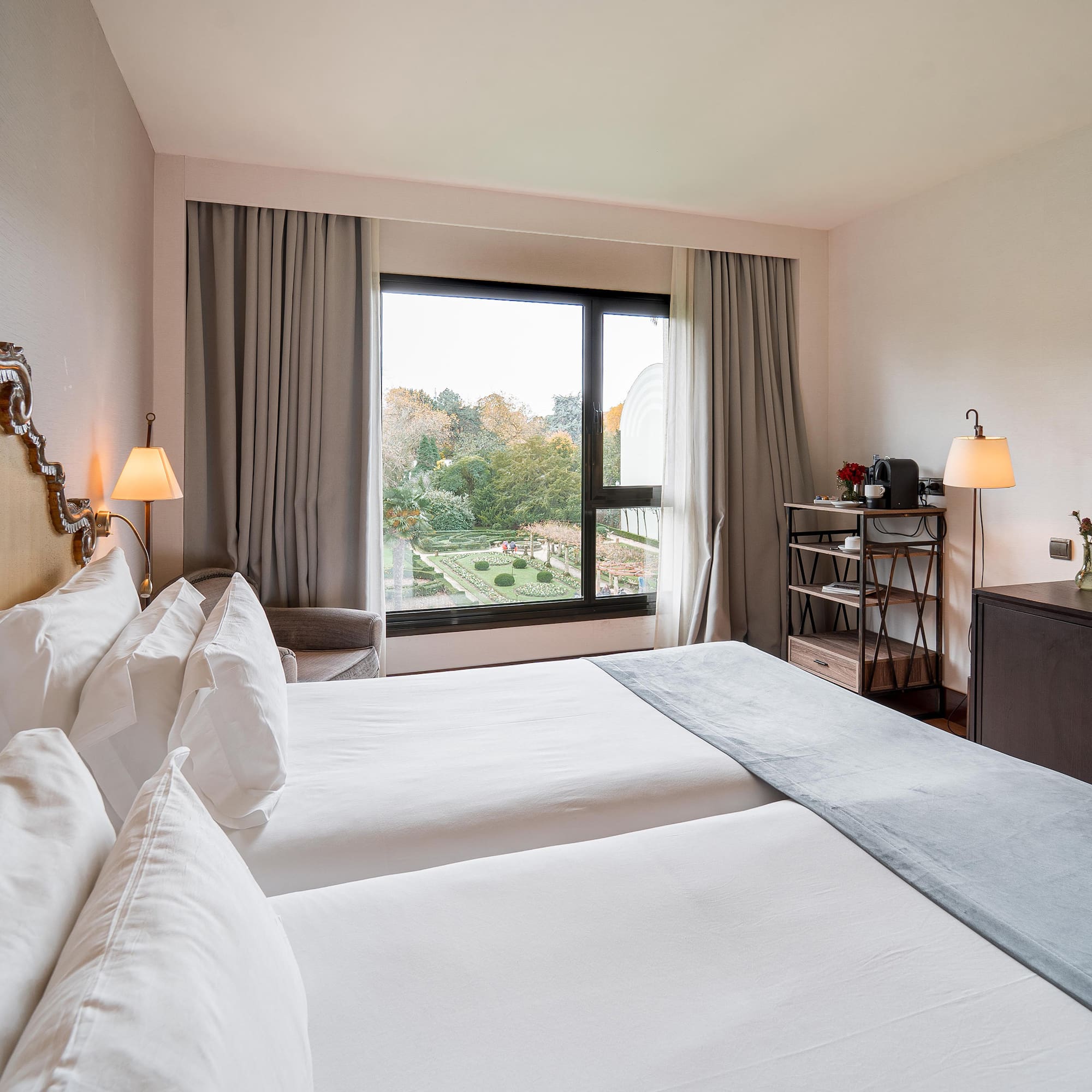 a room with two beds and a window